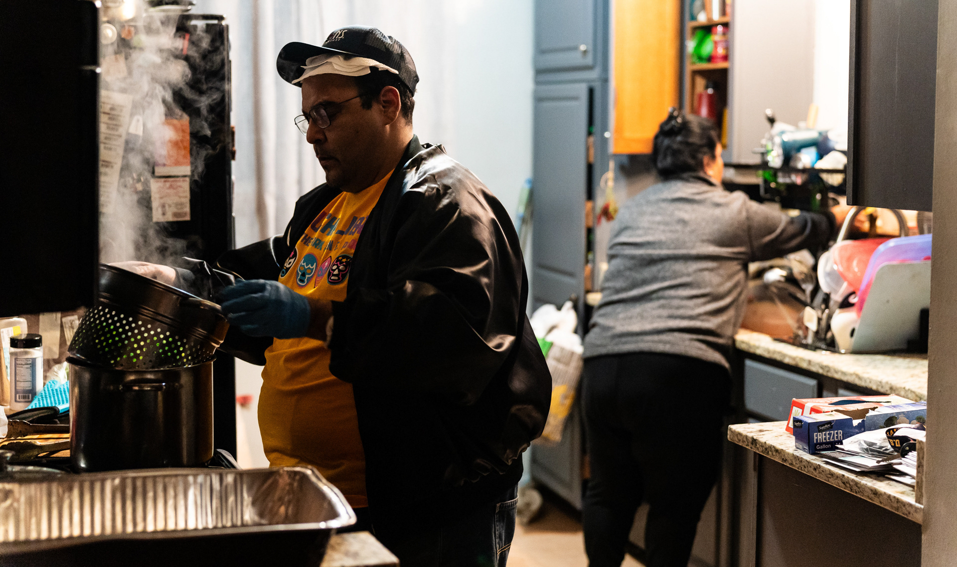 Daniel Cano prepares food with help from his mother at his home in Westchester, Illinois on November 17, 2023.