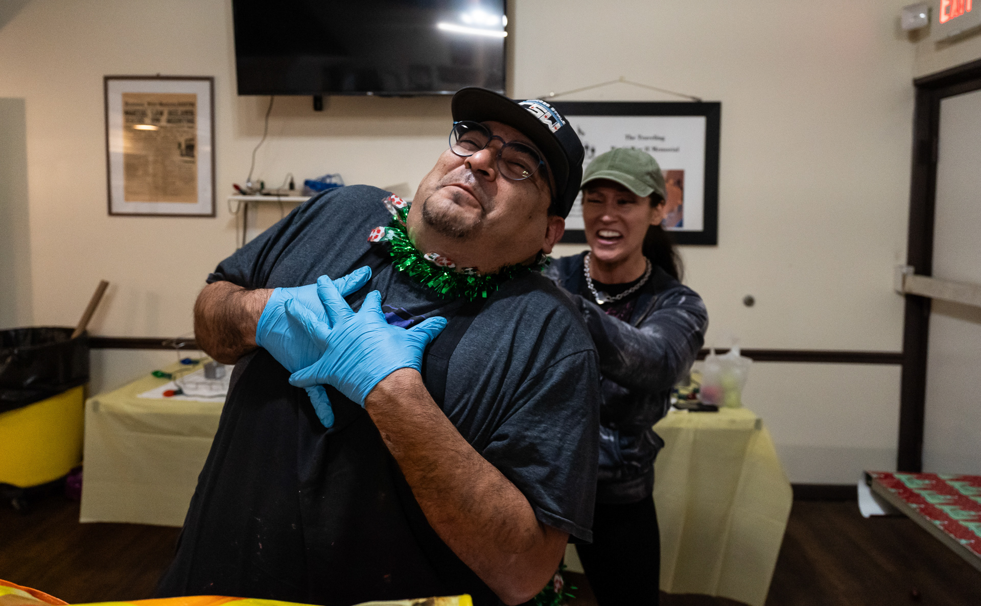 Daniel Cano jokes around with his friend Kimmy Zilla, another Chicago Style Wrestling wrestler and wife of Steve Boz, who mentored Cano in the organization, while setting up a holiday-themed afterparty at the American Legion Post 974 in Franklin Park, Illinois on November 17, 2023.