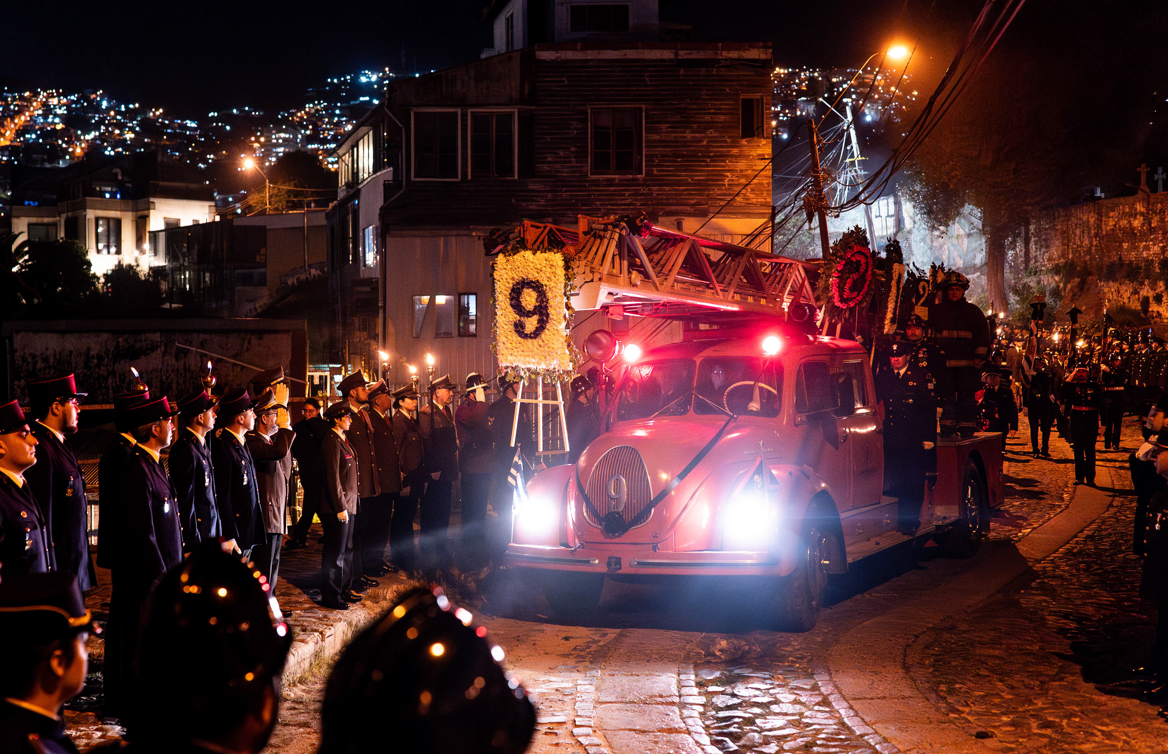 Volunteer firefighters watch as a fire truck carries the body of fellow volunteer Luis Rojas Ramírez from the Monumento al Bombero to Cementerio No. 1 in Valparaíso, Chile on Friday, September 6, 2024. Ramírez passed away on September 4 at 97 years old.