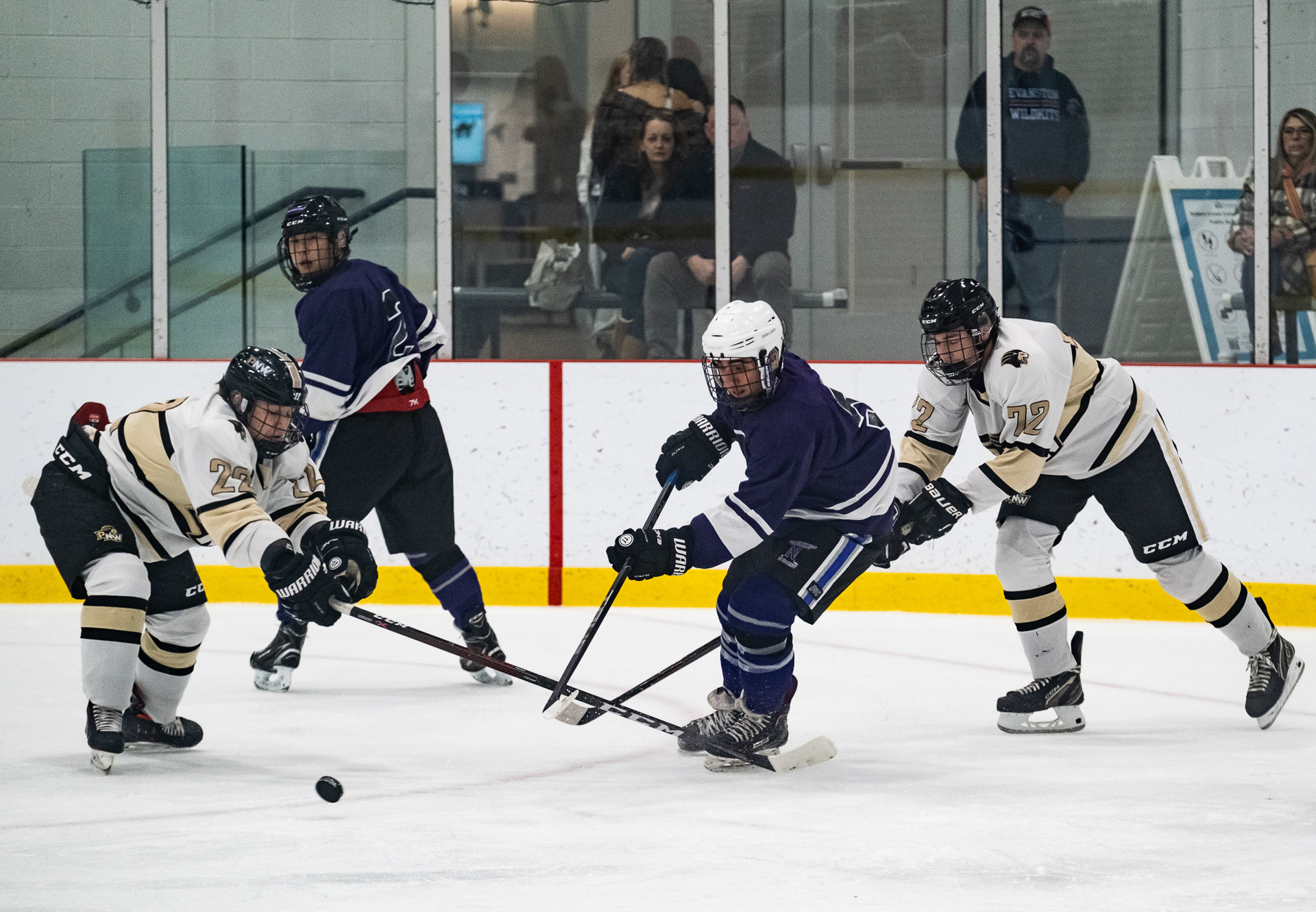 Northwestern club hockey team treasurer Evan Popat struggles with Purdue Northwest players for the puck at Robert Crown Community Center in Evanston, Illinois on October 29, 2022. For The Daily Northwestern.