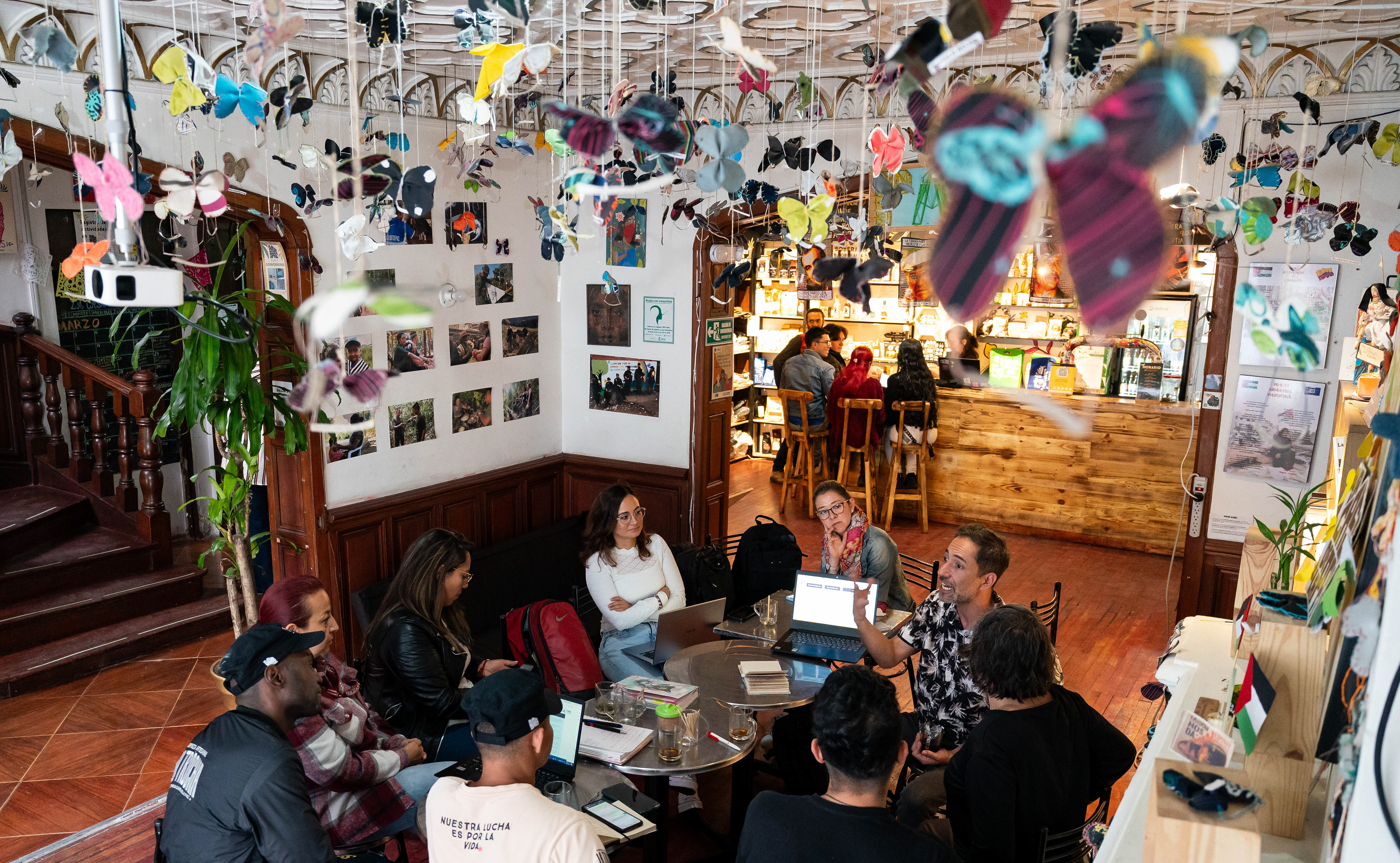 The leadership of La Casa de la Paz holds a meeting in Bogotá, Colombia on March 22, 2024. Butterflies hanging from the ceiling represent the over 400 firmantes who have been assassinated since the 2016 peace deal according to Indepaz.