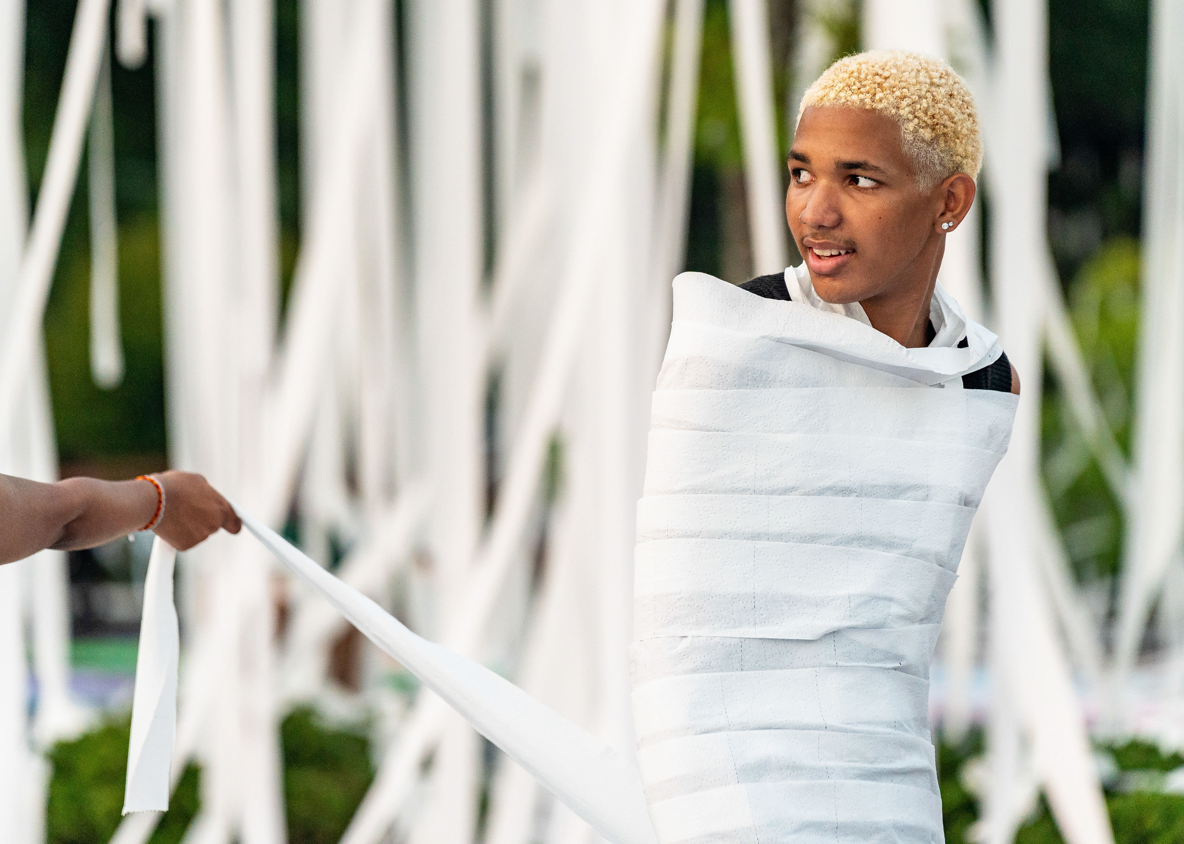 Incoming senior Jayden Coleman stands wrapped in toilet paper in the parking lot at Marietta High School in Marietta, Georgia on July 31, 2024. Atlanta Journal-Constitution
