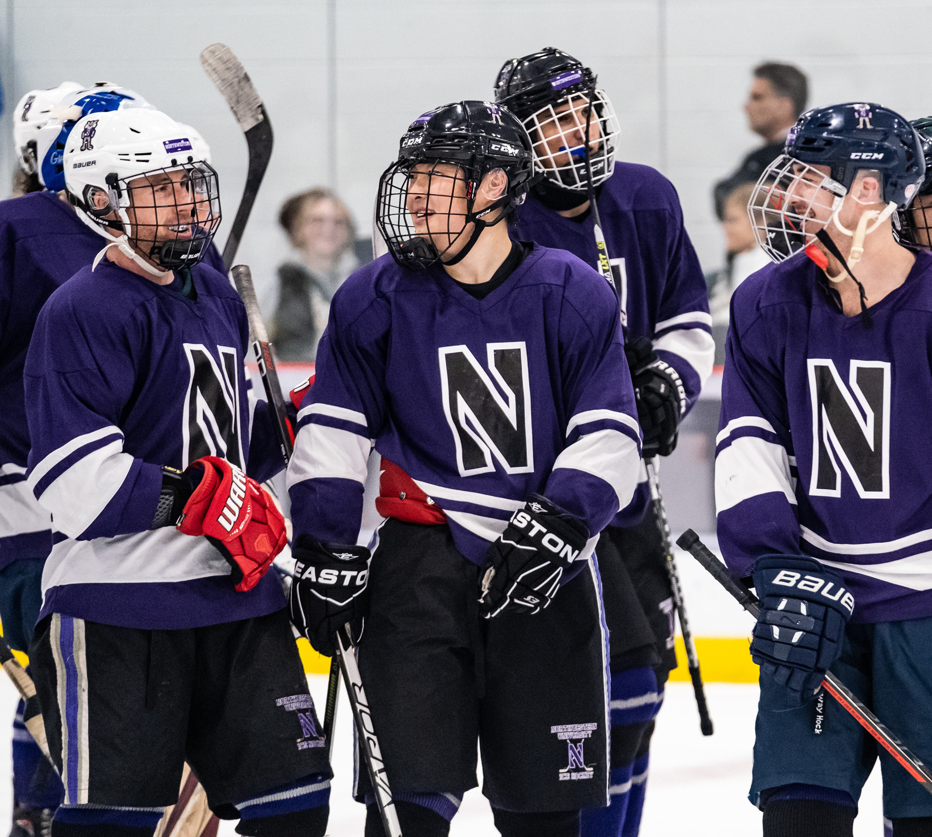 Northwestern club hockey team members come together on the rink after scoring the game-winning point in overtime against Purdue Northwest at Robert Crown Community Center in Evanston, Illinois on October 29, 2022. For The Daily Northwestern.