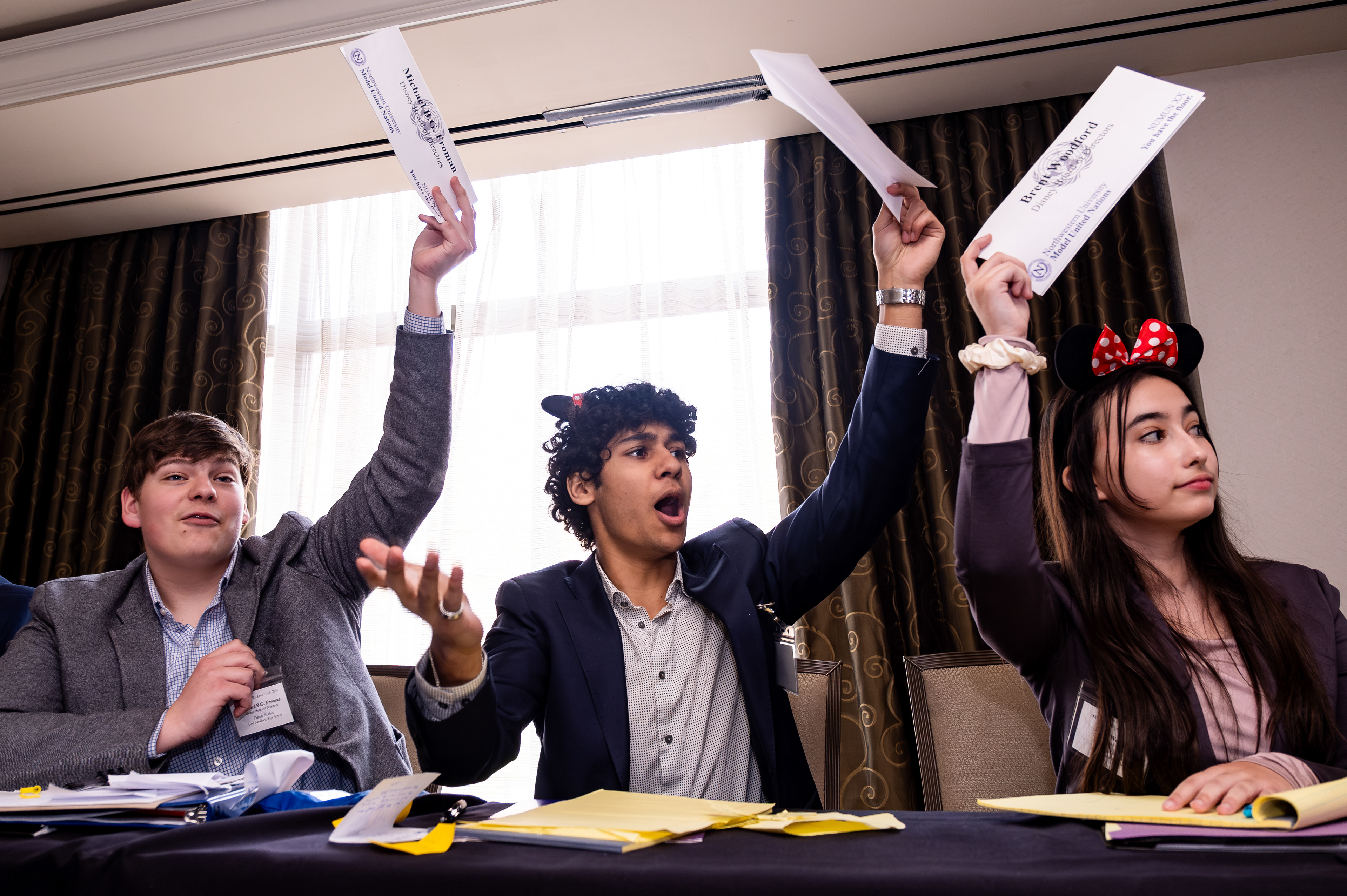 Delegates to the Disney Board of Directors panel of Northwestern University Model United Nations' high school conference raise their placards at the Hilton Orrington in Evanston, Illinois on April 15, 2023.