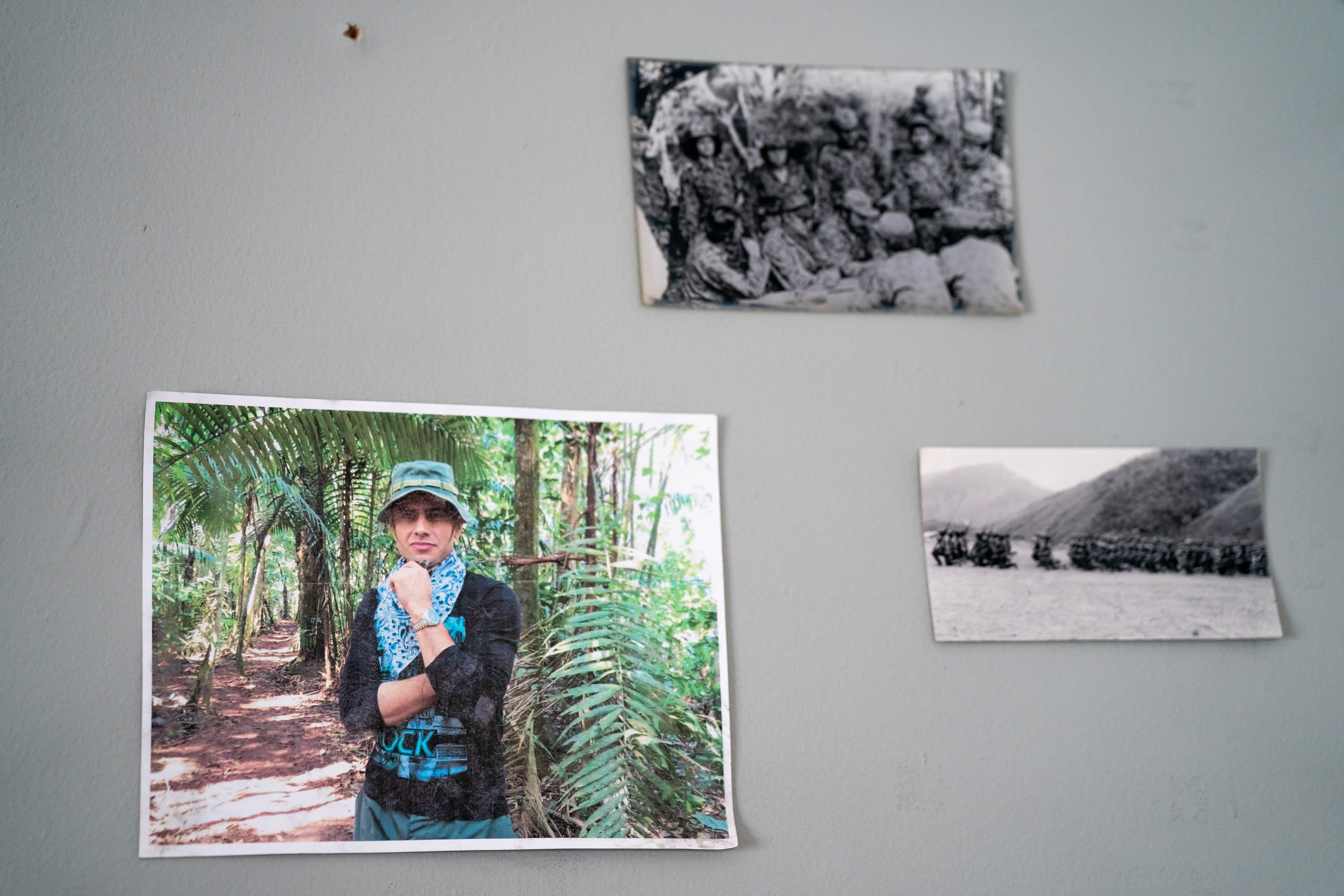 A photo of Manuel Bolívar from 2015, taken during his time in the FARC before the 2017 peace deal, seen on a wall with other photos at Casa Alternativa in Bogotá, Colombia on March 18, 2024. Casa Alternativa is a cultural house where Bolívar and other firmantes work, offering food, drinks and a social space.