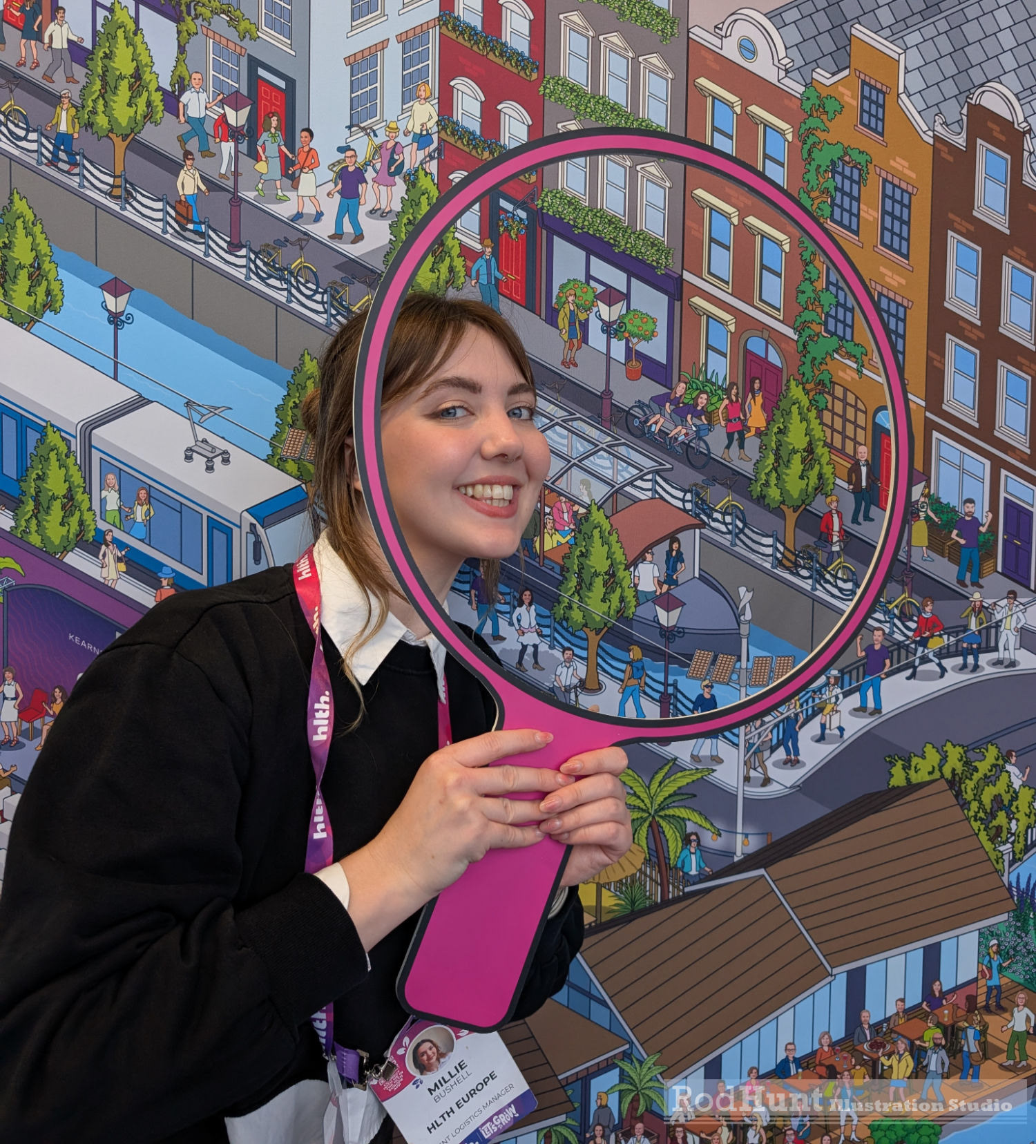 Millie finds herself in the Large Illustrated Printed Mural installation photo op wall at HLTH Europe conference in Amsterdam. A huge Where's Waldo / Wally style murals illustrated by Rod Hunt