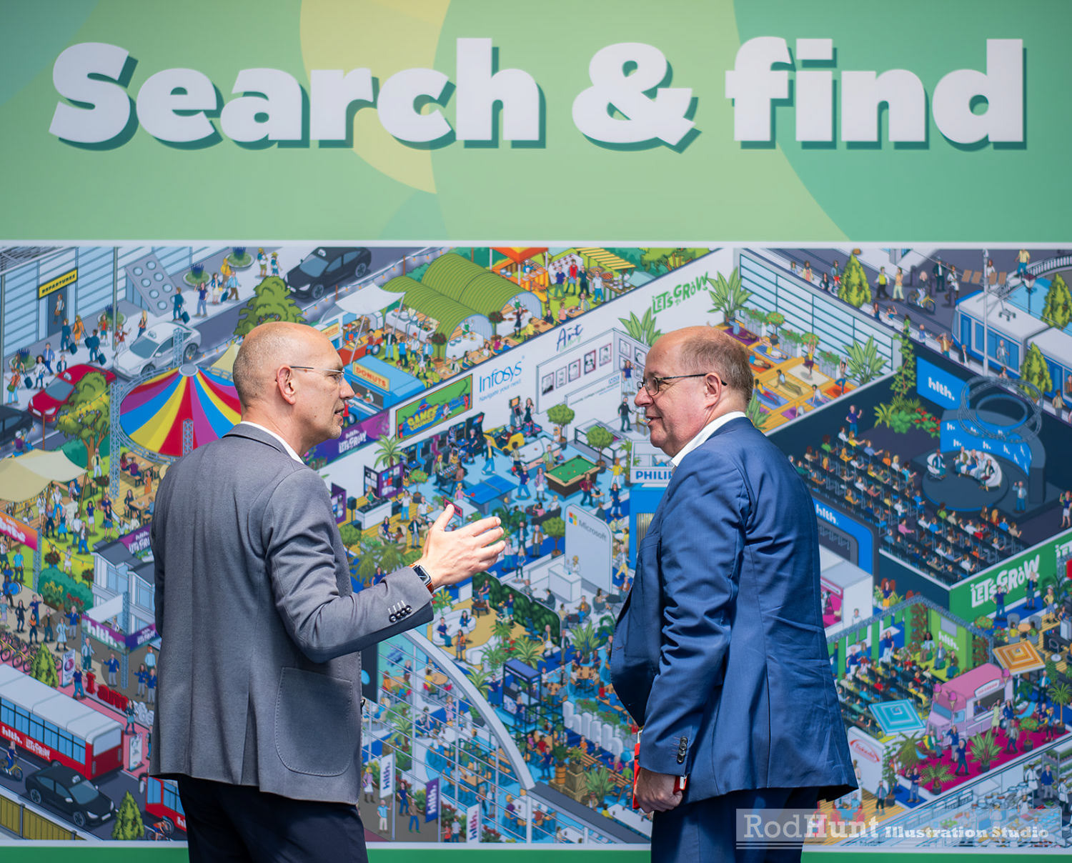 People in front of a huge detailed illustrated printed mural for photo op where you search for the conference speakers. Created in a Where's Waldo / Wally style
