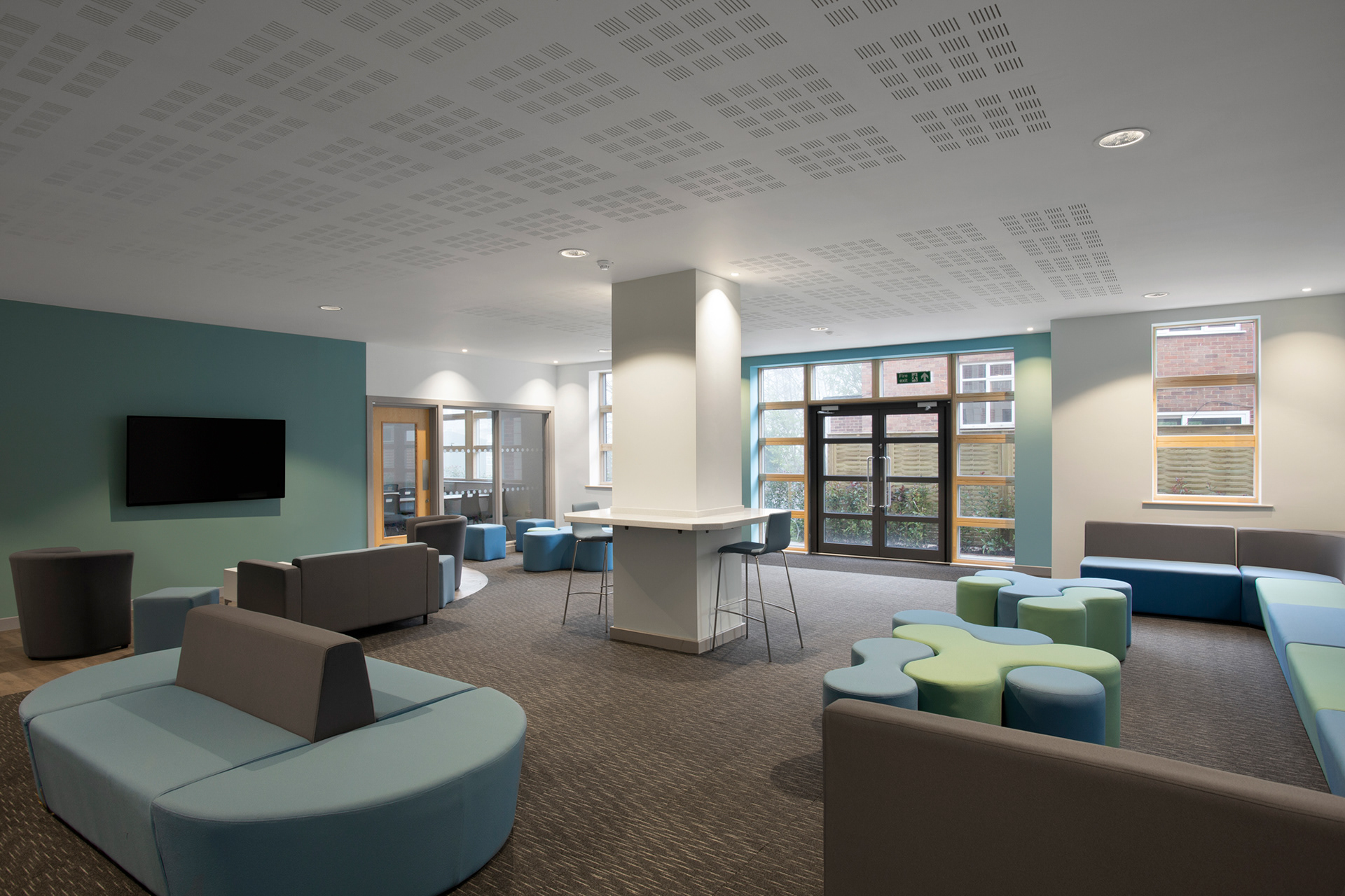 Photograph of a common room lounge with blue and grey coloured furniture