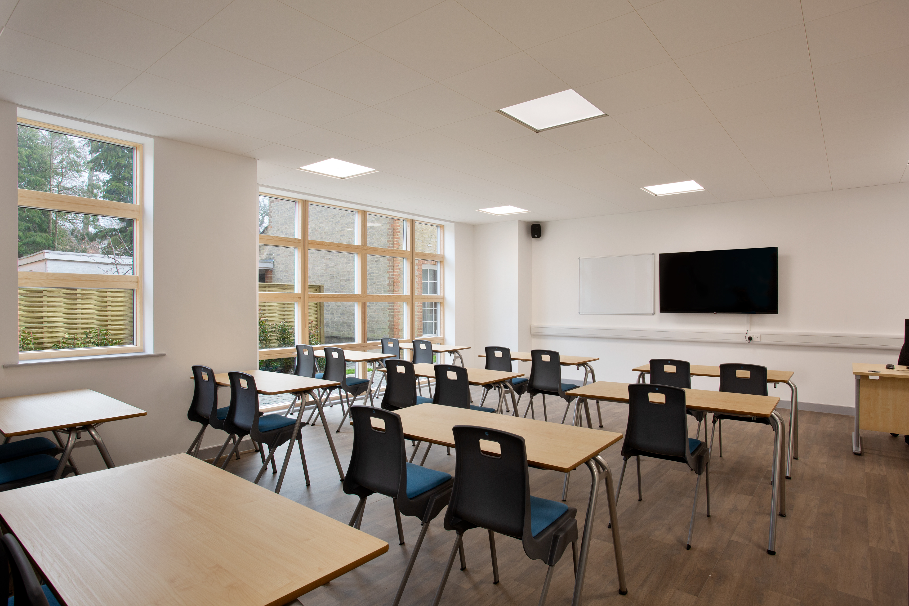 Photograph of a classroom with a Tv on the wall