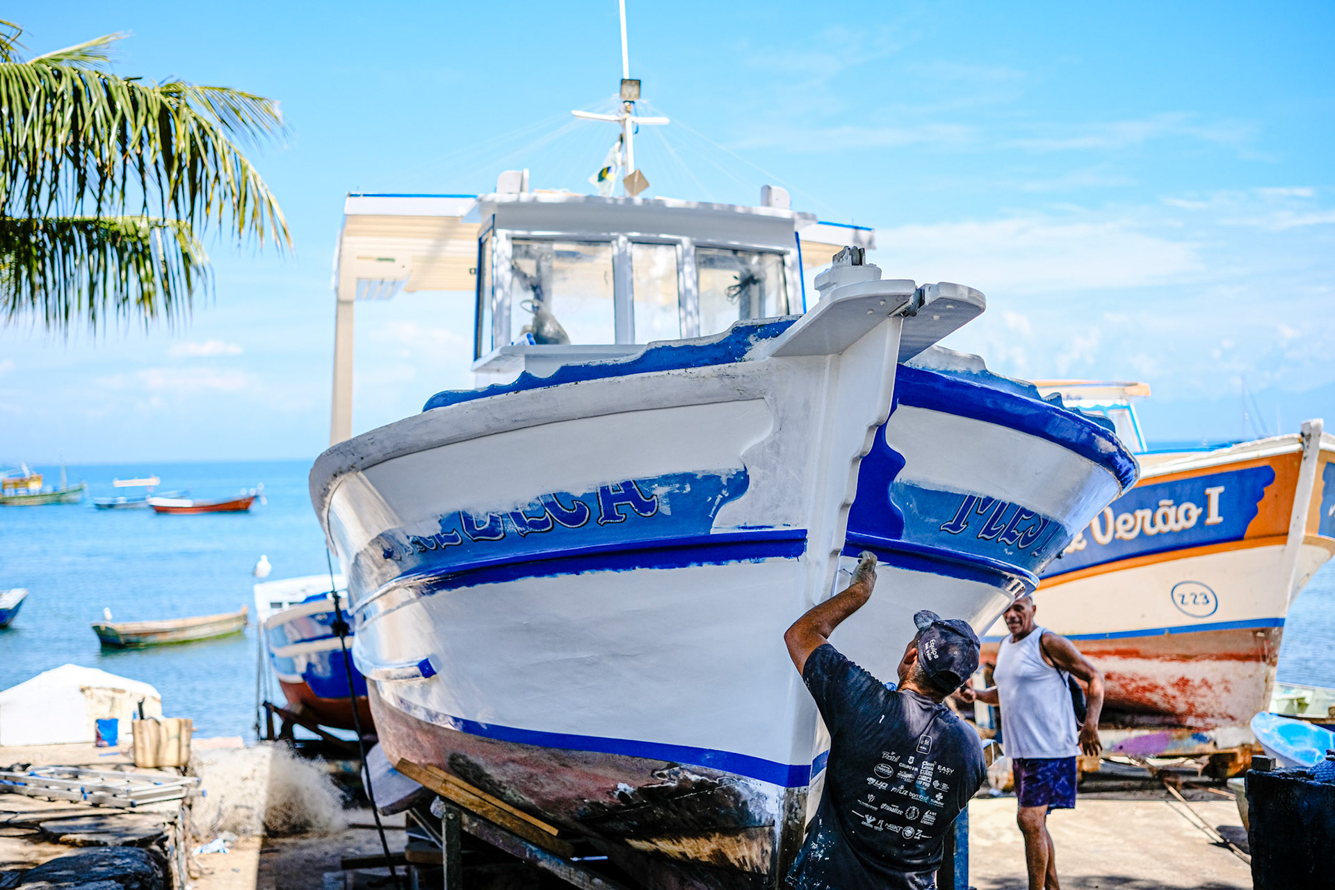 Fisherman re-painting a boat, Búzios, Rio de Janeiro