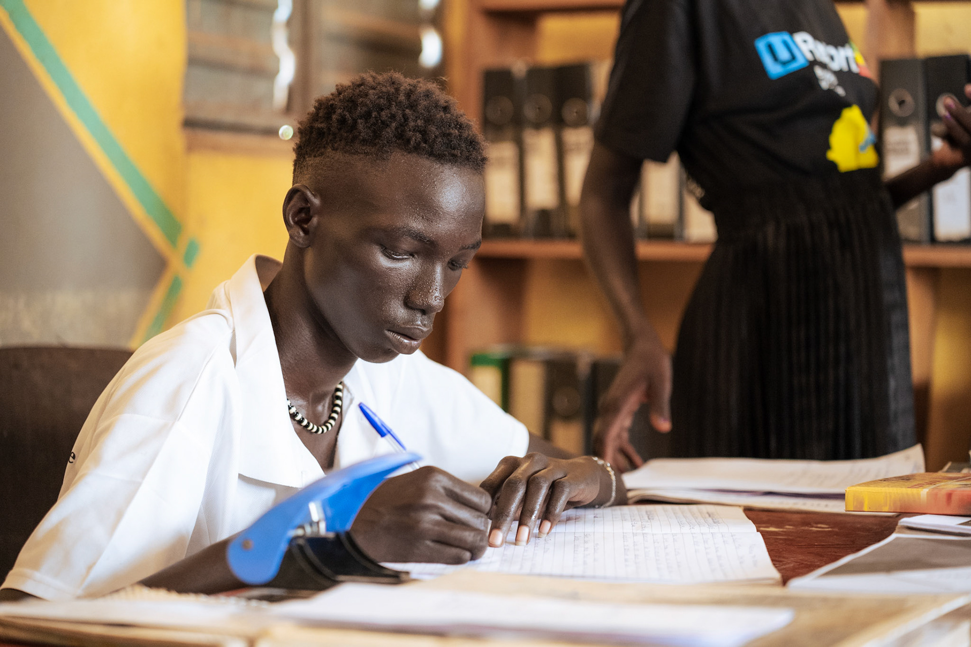 Adolescent takes notes of action agreed by the group