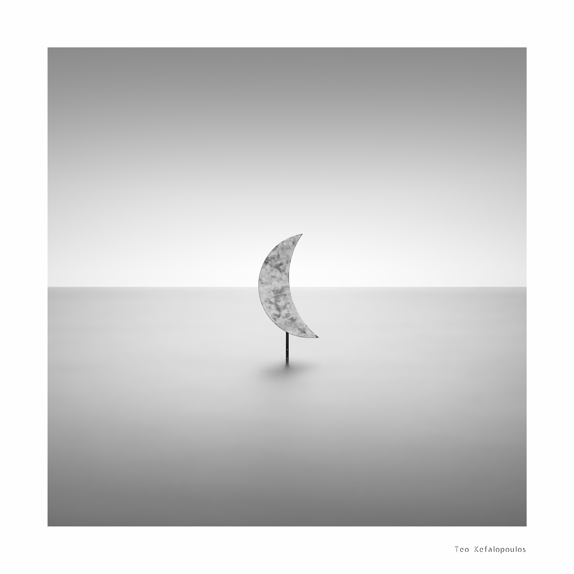 moon above a pale sea