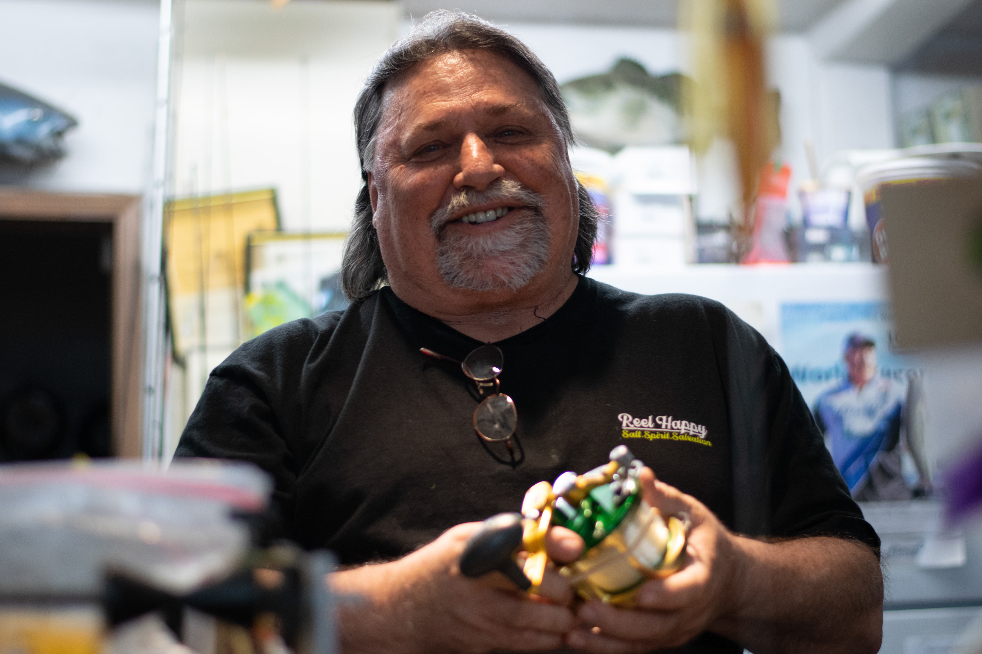 Bill van Wulven, owner of Barnacle Bill’s Bait and Tackle in Lemon Grove, respools a fishing reel for a customer on July 16. After 20 years of ownership, van Wulven is retiring and selling the store to Dana Landing.