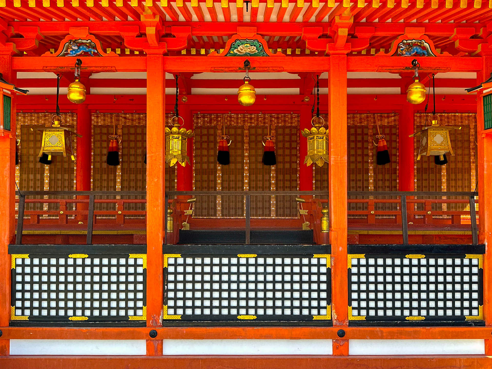 Red shrine with gold lanterns at Fushimi Inari, Kyoto, Japan