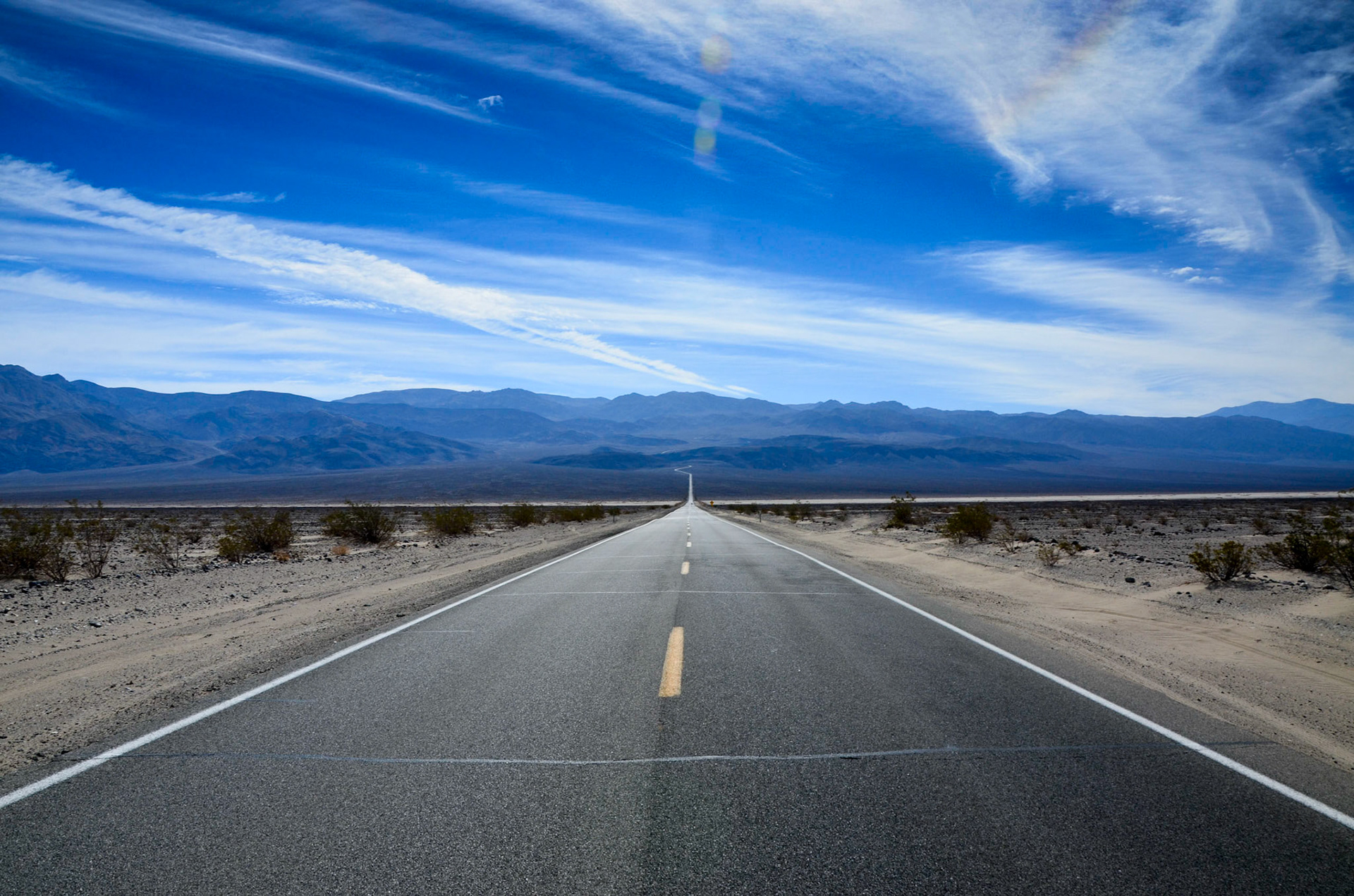 Route 190 receding straight into the distance in Death Valley, California