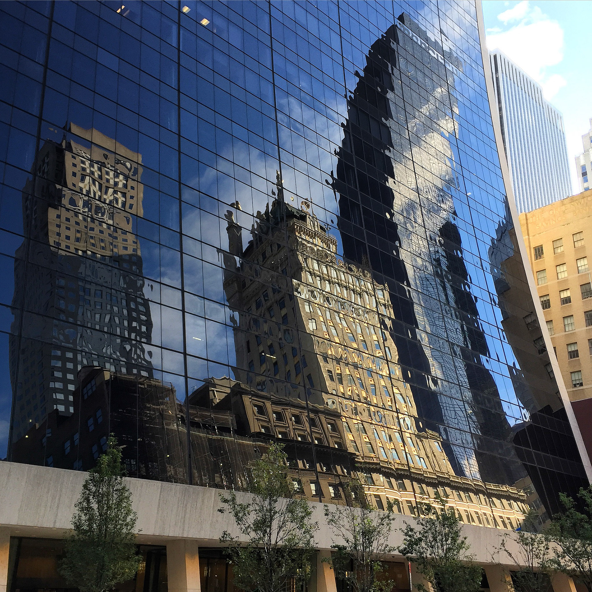 Buildings reflected in the black glass of 9 West 57th Street, New York