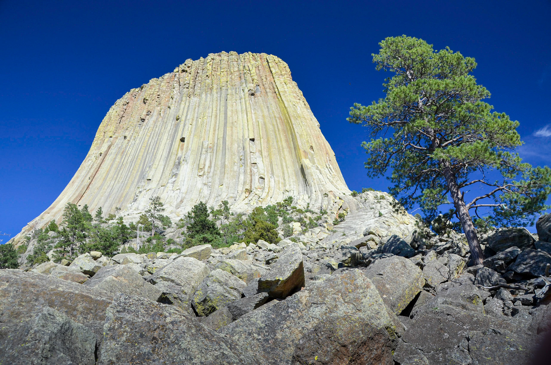Looking up at Devils Tower against a deep blue sky