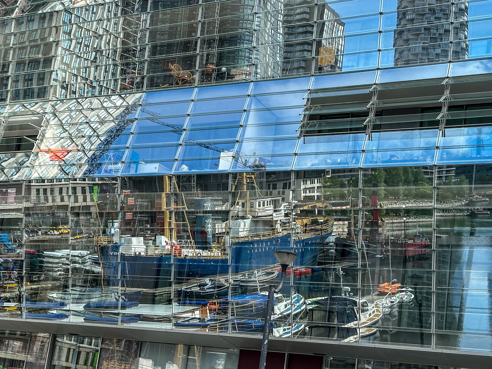 Reflections in a glass facade at Millwall Inner Dock, Docklands, London