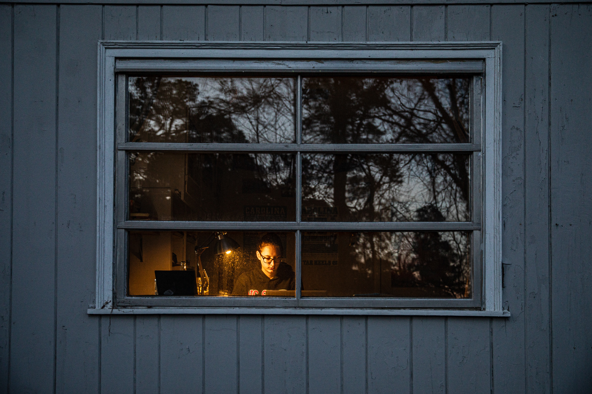 Kyle McClintock, a junior chemical engineering major at NC State, poses for a portrait at a desk in a house in Chapel Hill, N.C., March 8, 2021. All of her classes have been online since lockdowns began a year prior in March of 2020.