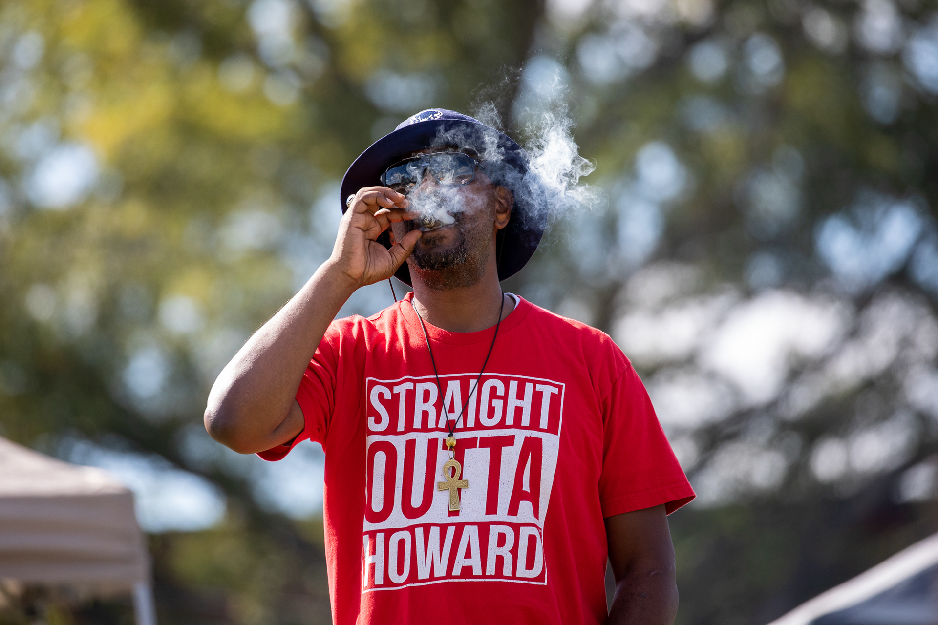 A Howard fan smokes a cigar at a tailgate before a football game at NC A&T in Greensboro, N.C., Saturday, Oct. 26, 2019. The Bulldogs beat the Bison 64-6 in their homecoming game.