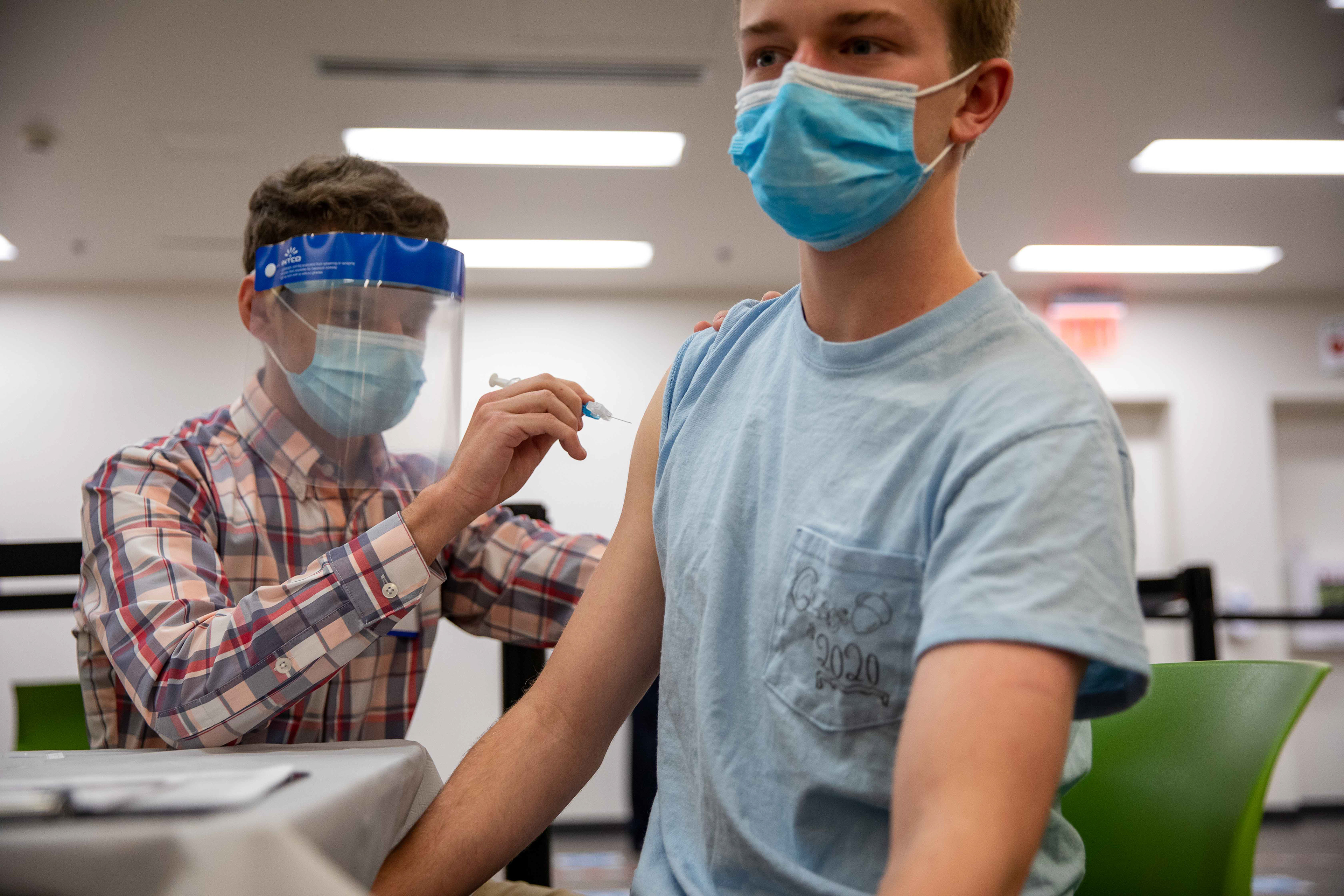 The first vaccine dose given at UNC’s vaccination clinic is administered.