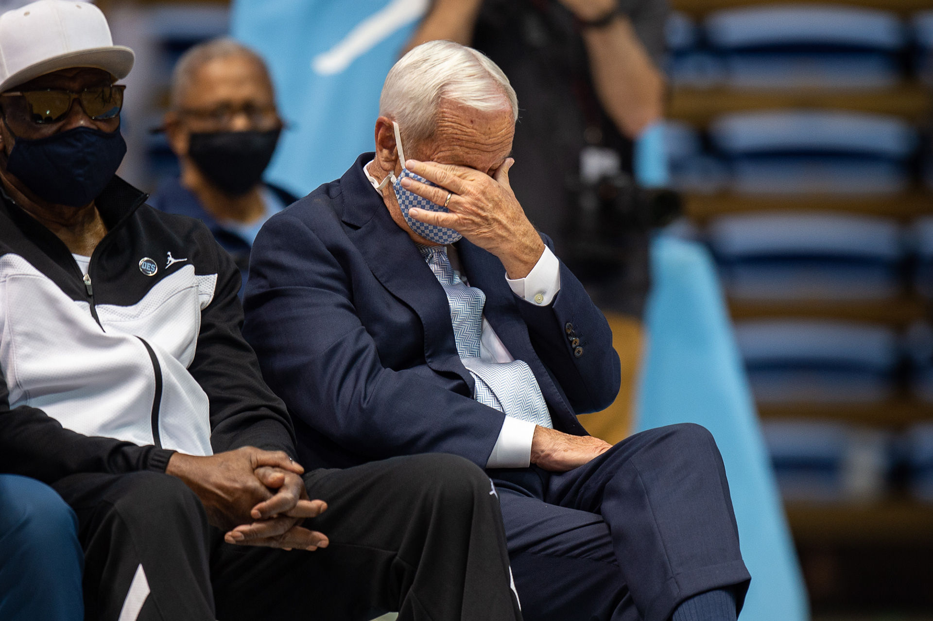 Former UNC men’s basketball coach Roy Williams sheds a tear as new head coach Hubert Davis recalls a story at a press conference in the Dean E. Smith Center in Chapel Hill, N.C., April 6, 2021. Davis spent many years under Williams as both a player and an assistant coach.