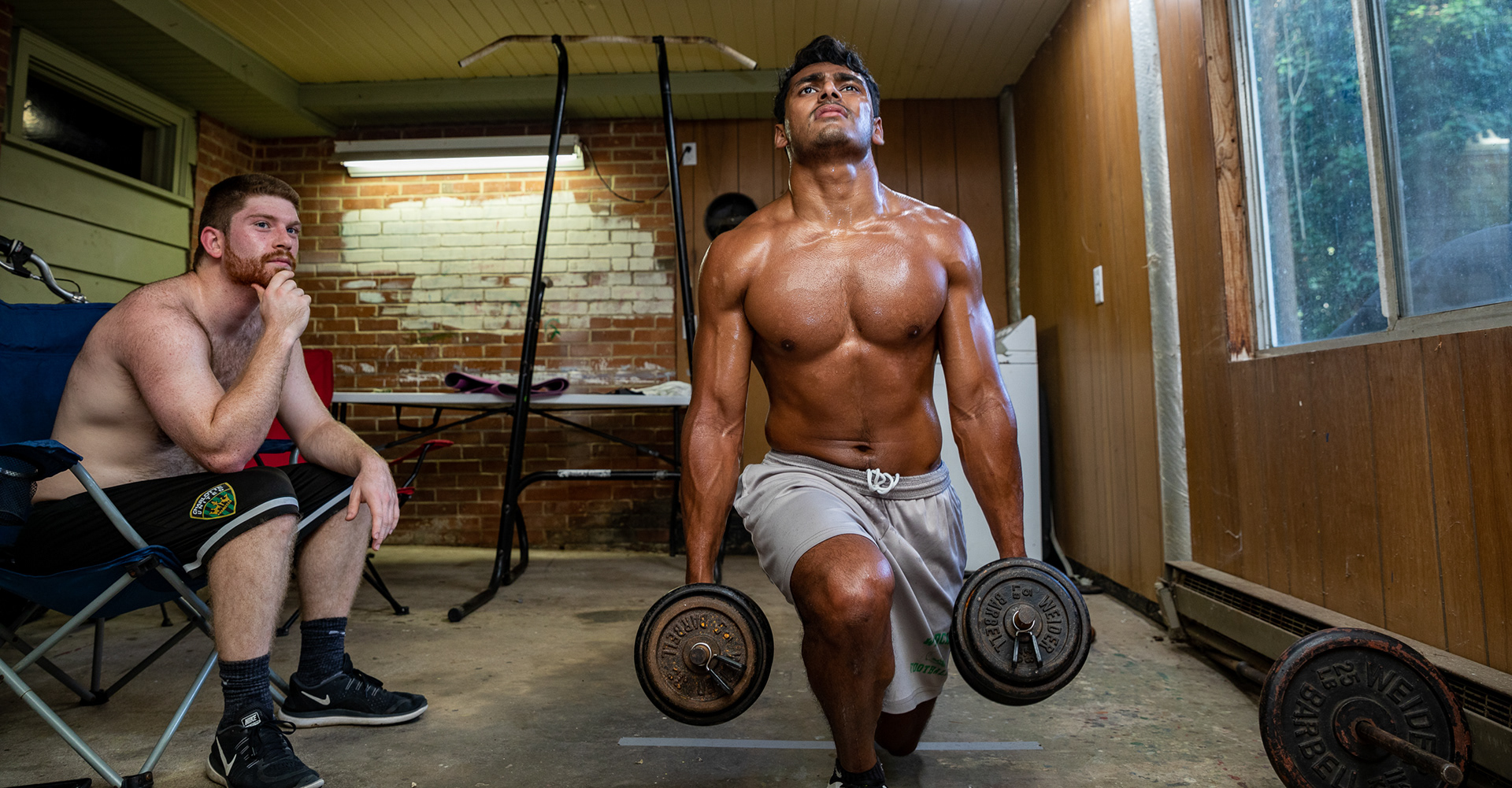 UNC club rugby players Philip Patterson and Neeral Patel work out in the basement of their home in Chapel Hill, Sept. 1, 2020. After gyms shut down under statewide coronavirus lockdown orders, they have had to figure out ways to train on their own.