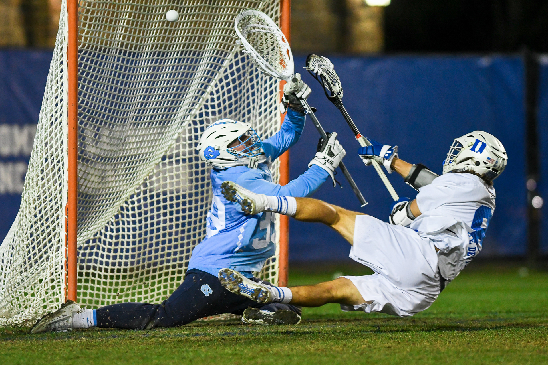 First Place in Sports Action Category | Duke senior attacker Joe Robertson (8) scores the game-winning goal in Koskinen Stadium in Durham, N.C., April 1, 2021. The Blue Devils beat the UNC Tar Heels 12-11 in a dramatic overtime finish between the #1 and #2 teams in the nation.