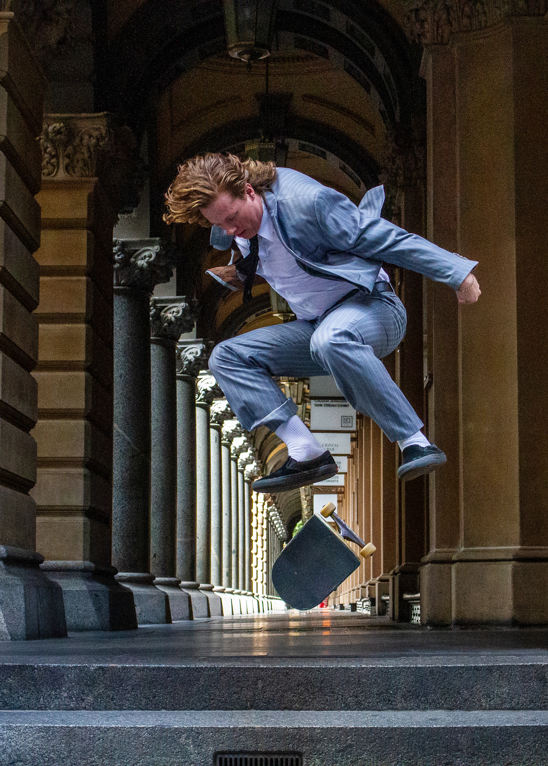 A skateboarder does a kick flip off of the stairs of the historic General Post Office building in Sydney, March 21, 2020. Due to government closures of many businesses in the wake of the growing COVID-19 pandemic, many parts of the usually bustling downtown were nearly empty.