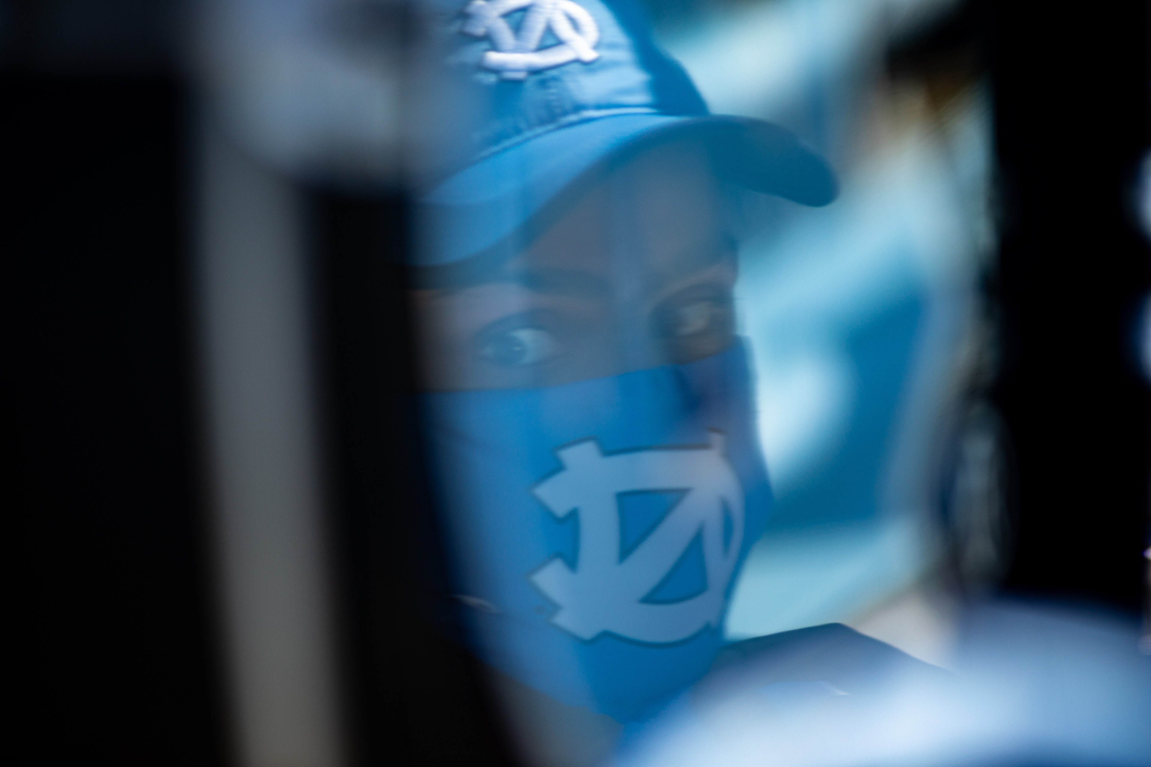Reflection in a bass drum of a member of UNC’s drum line during a football game in Kenan Stadium in Chapel Hill, N.C., Oct. 24, 2020. A limited number of band members were allowed to play at football games as coronavirus lockdowns began to be relaxed in North Carolina.