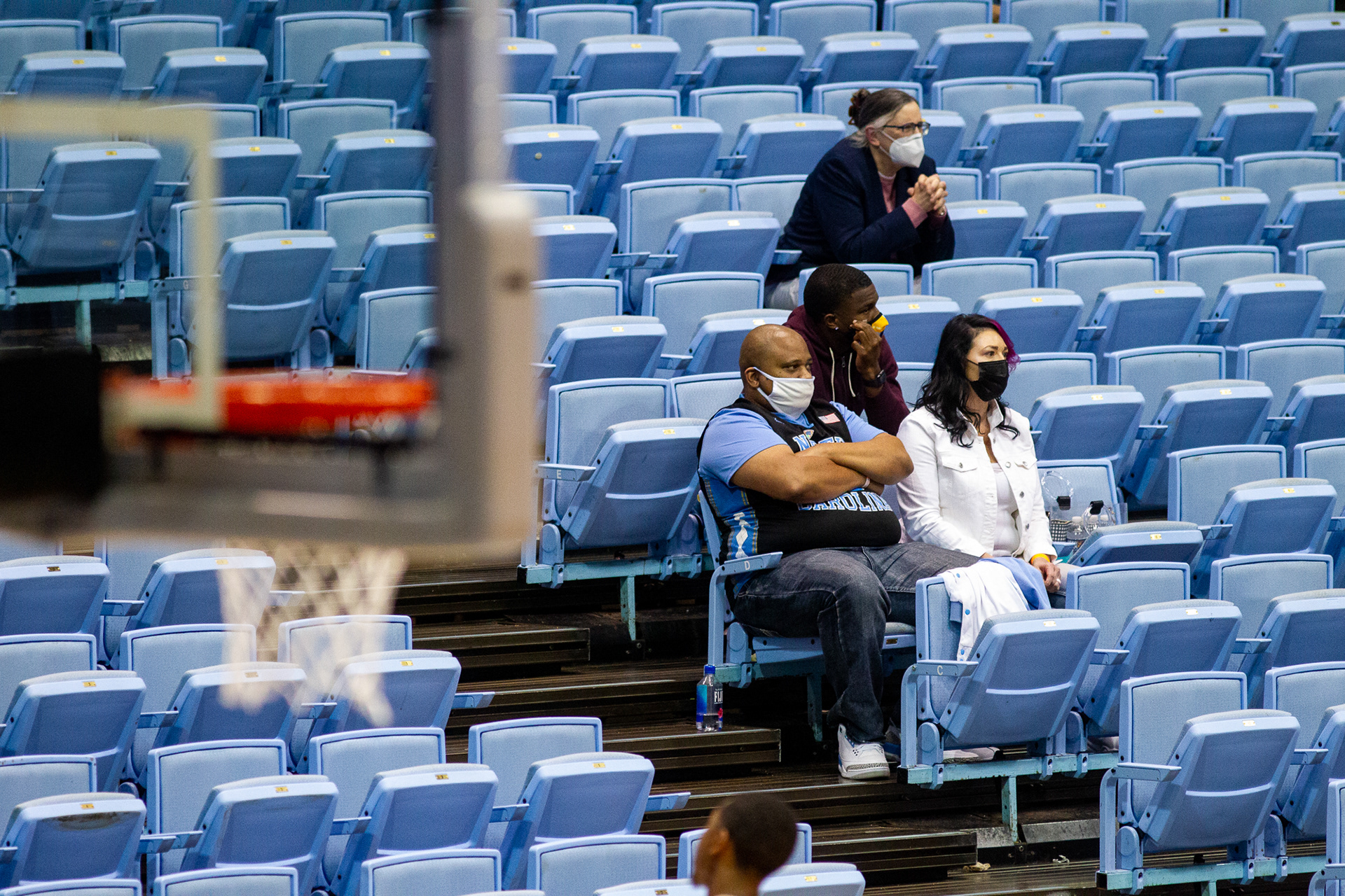 Fans look on as UNC plays Wake Forest in the Dean E. Smith Center in Chapel Hill, N.C., Jan. 20, 2021. Only a few family members were allowed to attend the game and had to wear masks and socially distance.