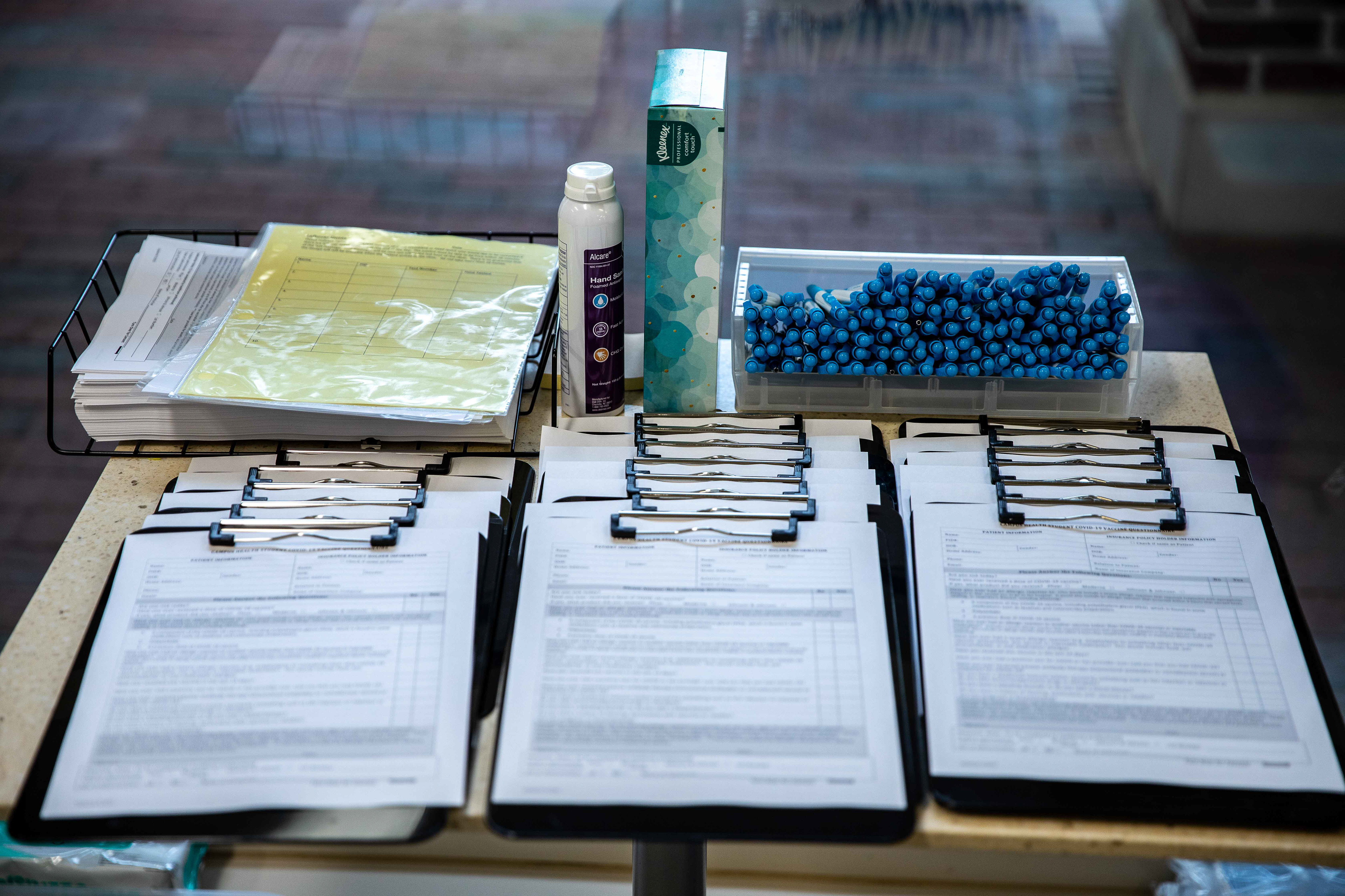 Forms and hand sanitizer lie at the entrance of the vaccination clinic.