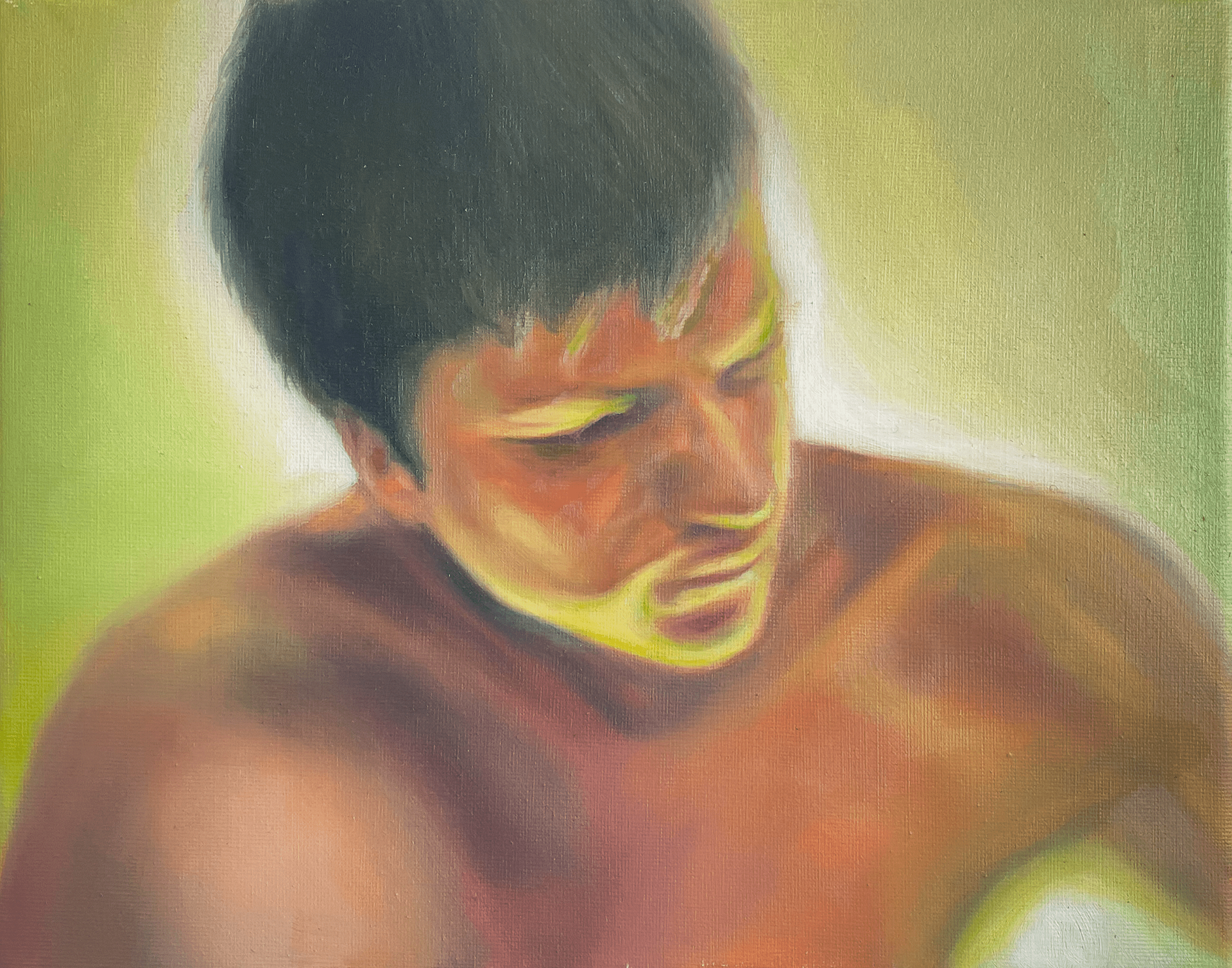 portrait of a young man with the shine of a greenish light source from the ground on his facee of