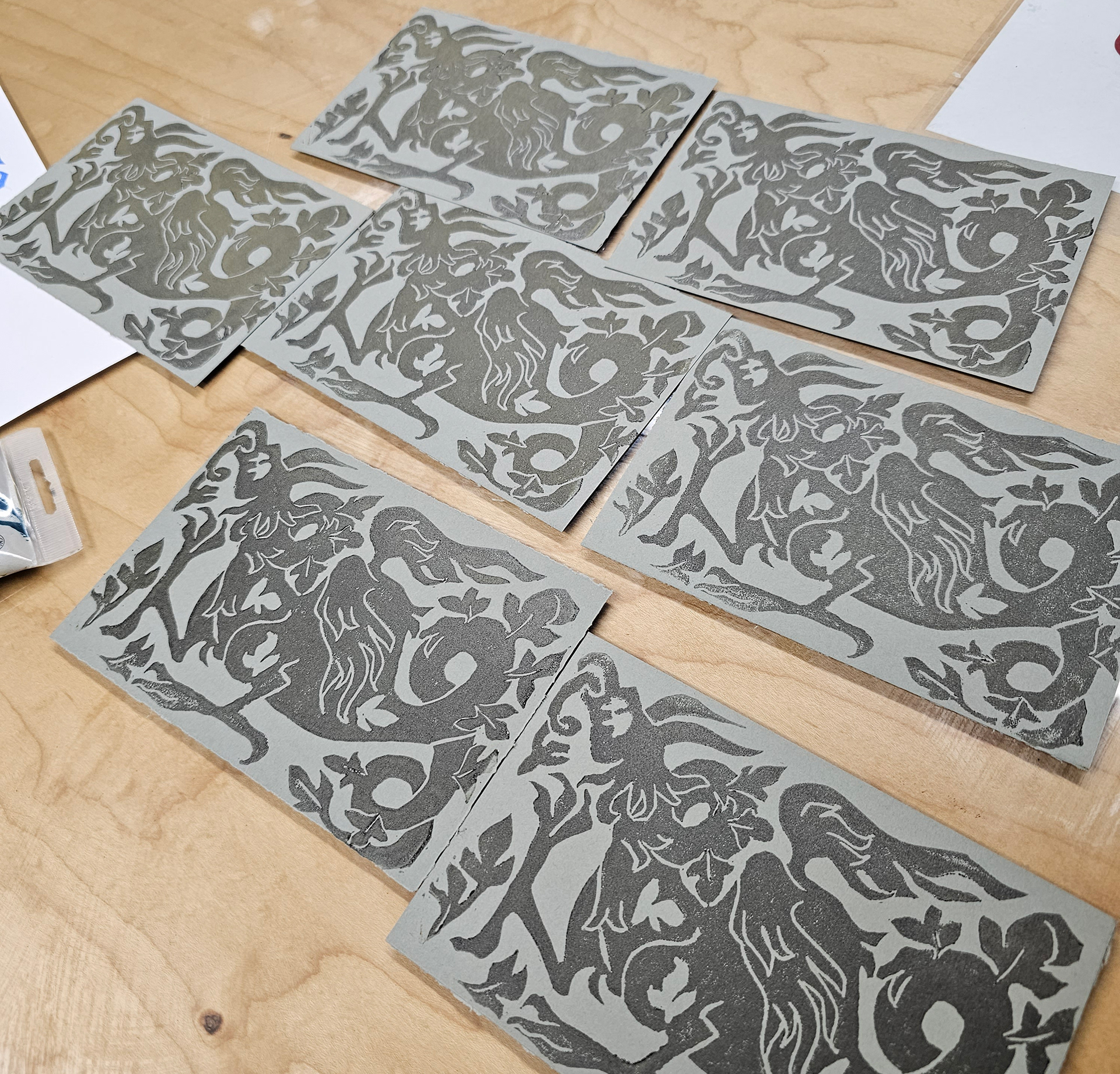 Dragon linocut postcards in graphite ink