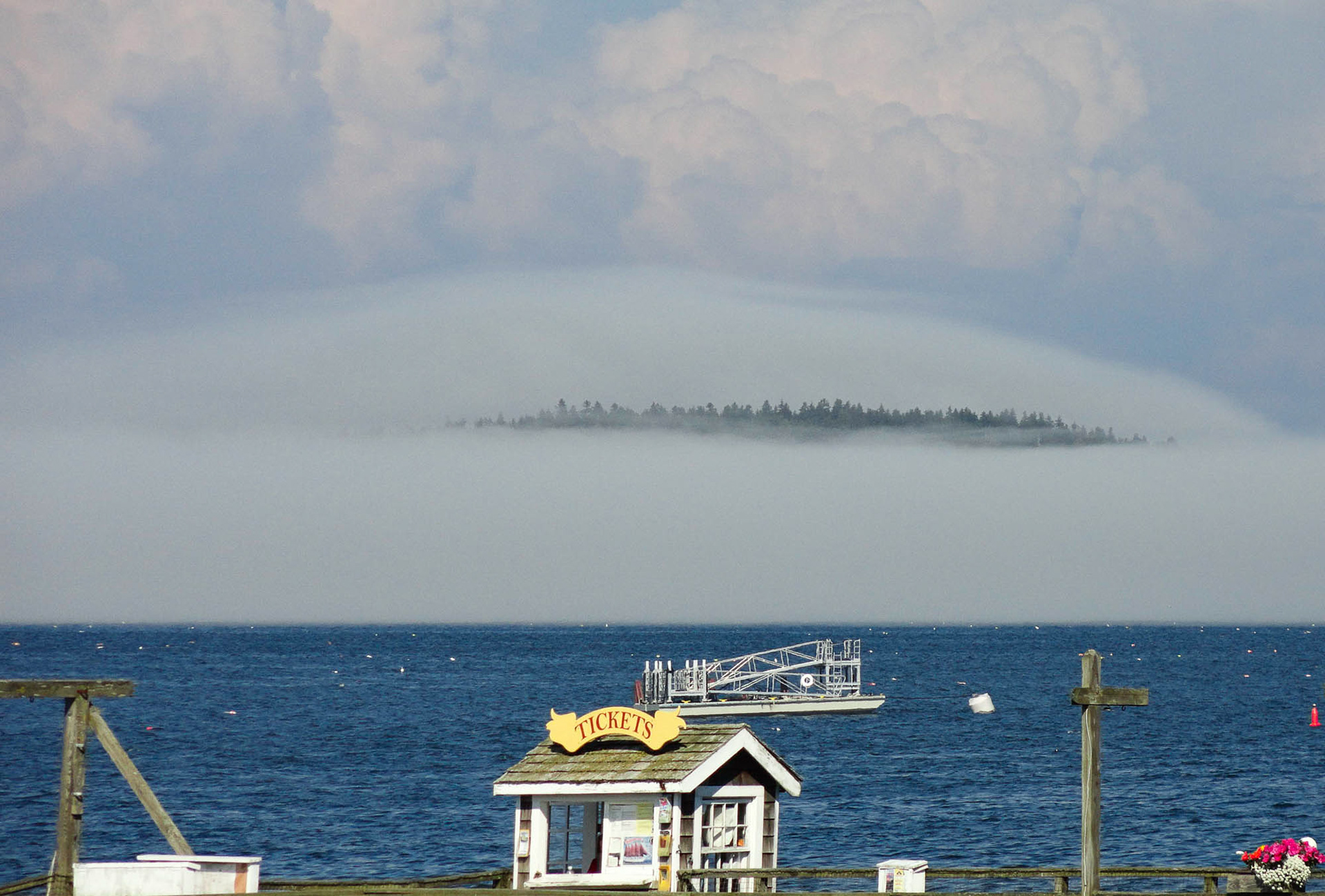 An island surrounded by fog, seen from Bar Harbor, Maine