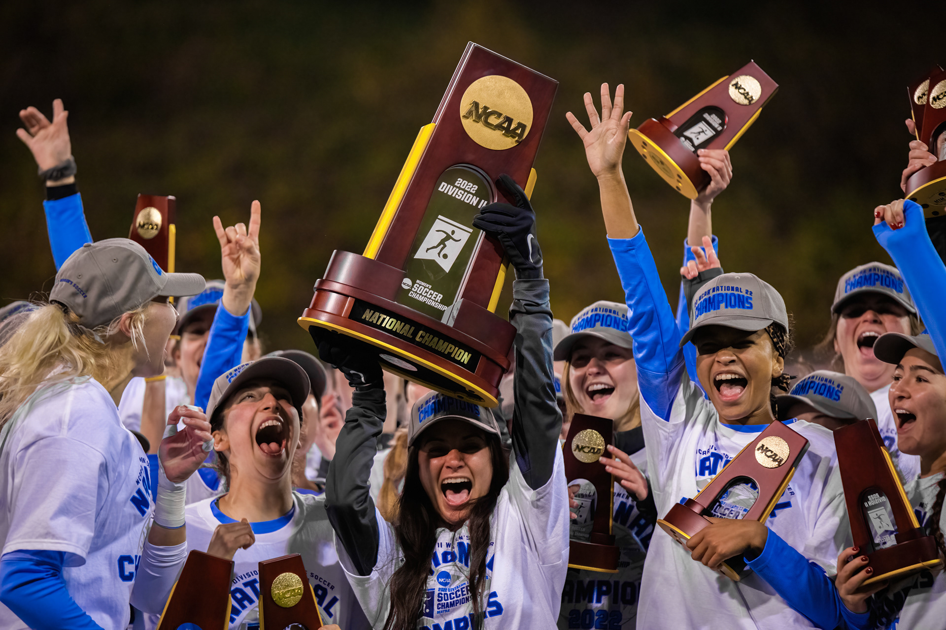 Western Washington University defender Karina Provo (16) is surrounded by teammates as she lifts the trophy after the Western Washington University Vikings defeated the West Chester University Rams 2-1 in the NCAA Division II National Championship Game at Interbay Stadium in Seattle, Wash., on Dec. 3, 2022.