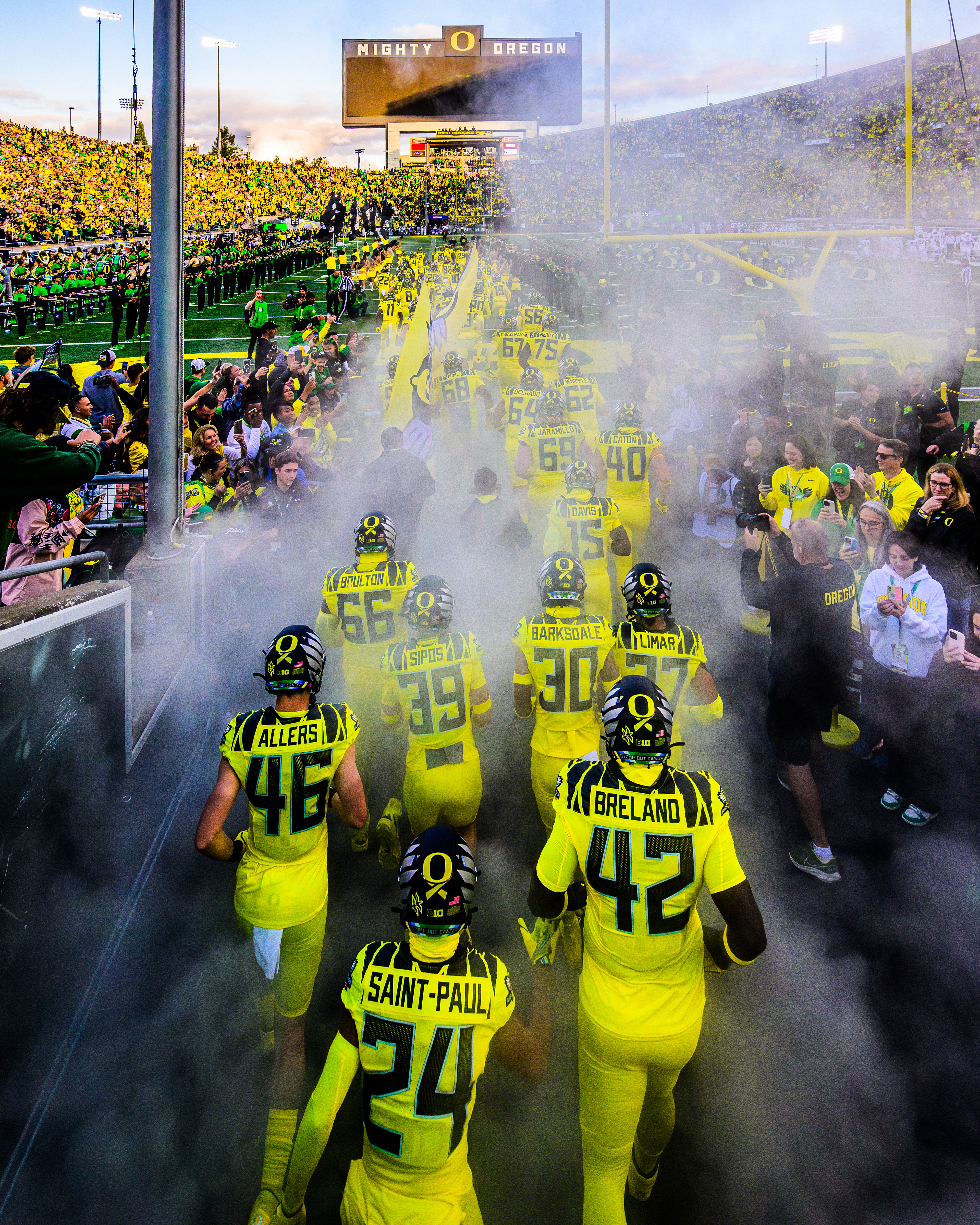 Oregon Ducks Football team members take the field before their home game against the Michigan State University Spartans at Autzen Stadium in Eugene, Ore., on Oct. 4, 2024. Since 1997, the Ducks have been led onto the field by a custom Harley-Davidson motorcycle with the Oregon Duck riding on the back.
