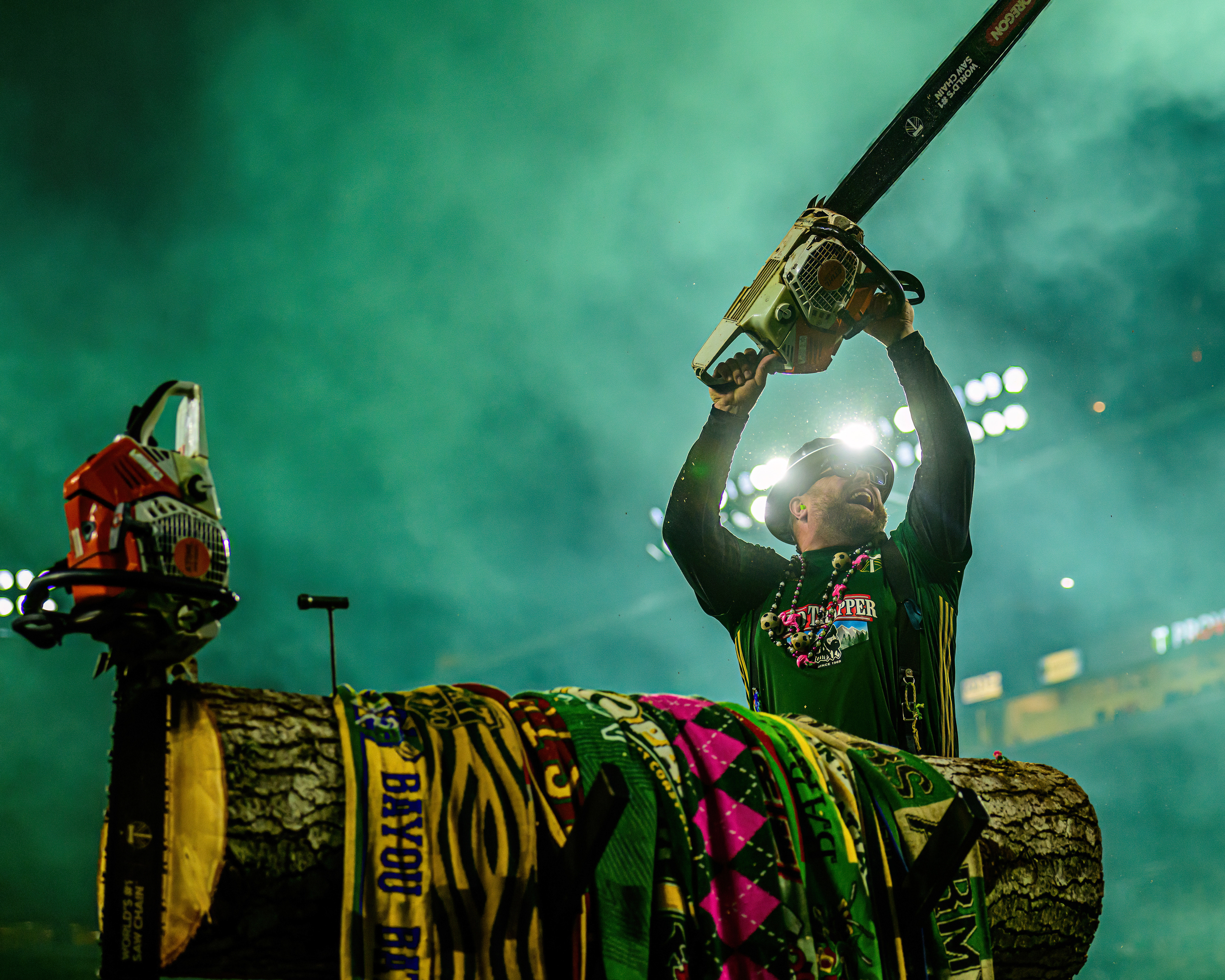 Portland Timbers FC mascot Timber Joey raises a chainsaw above his head while facing the Timbers Army supporters section during a match against Sporting Kansas City FC at Providence Park in Portland, Ore., on May 25, 2024.  