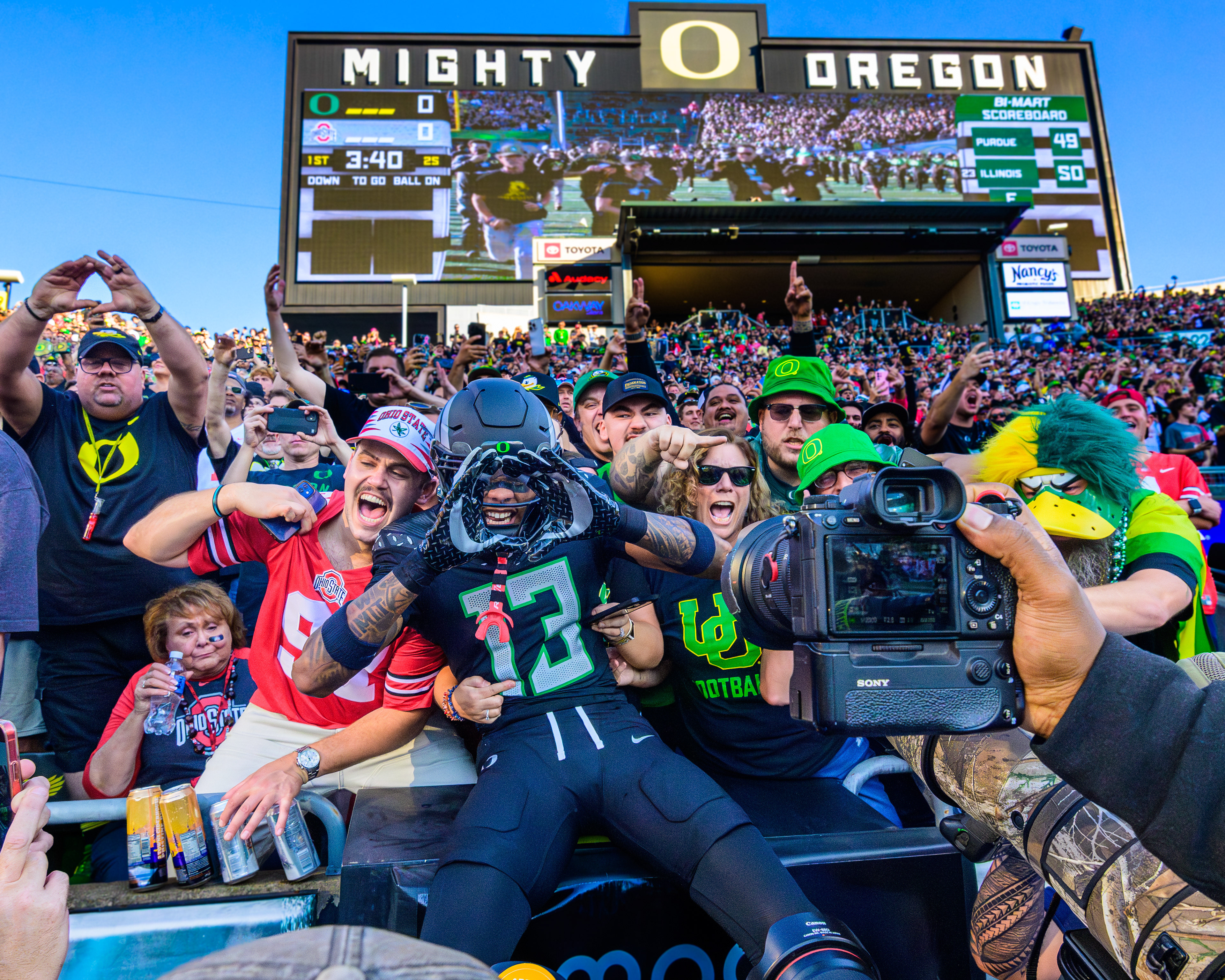 Oregon Ducks defensive back Sione Laulea, #13, leaps into a group of fans during the opening run-out before the Oregon vs. Ohio State football game. The University of Oregon Ducks defeated the Ohio State Buckeyes 32-31 on Saturday, October 12, 2024, in front of a record 60,129 attendees at Autzen Stadium in Eugene, Oregon.