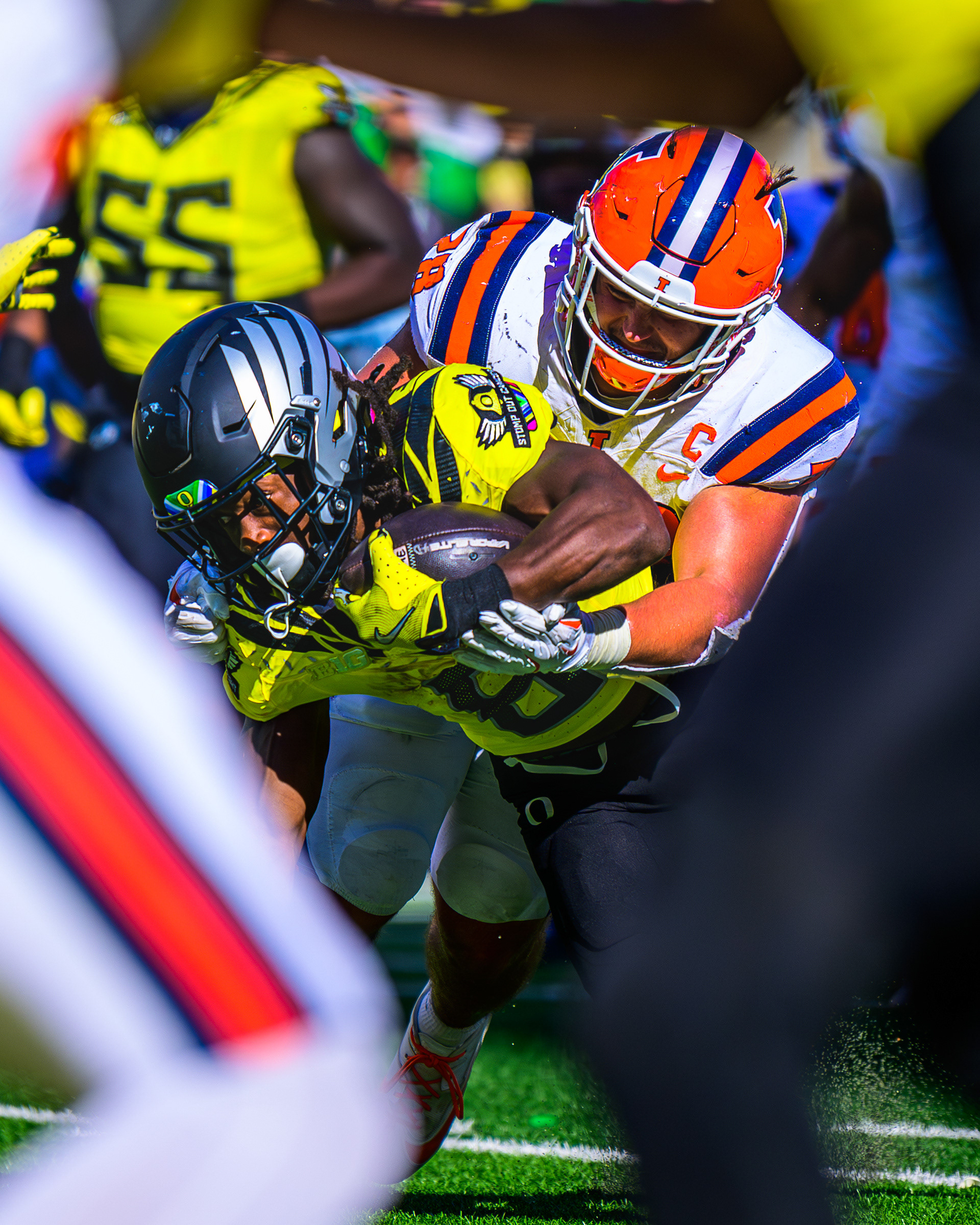 Oregon Ducks running back Noah Whittington, #6, fights through a tackle by Illinois Fighting Illini linebacker Dylan Rosiek, #28, near the endzone during a game against the University of Illinois Fighting Illini at Autzen Stadium in Eugene, Ore., on Oct. 26, 2024.
