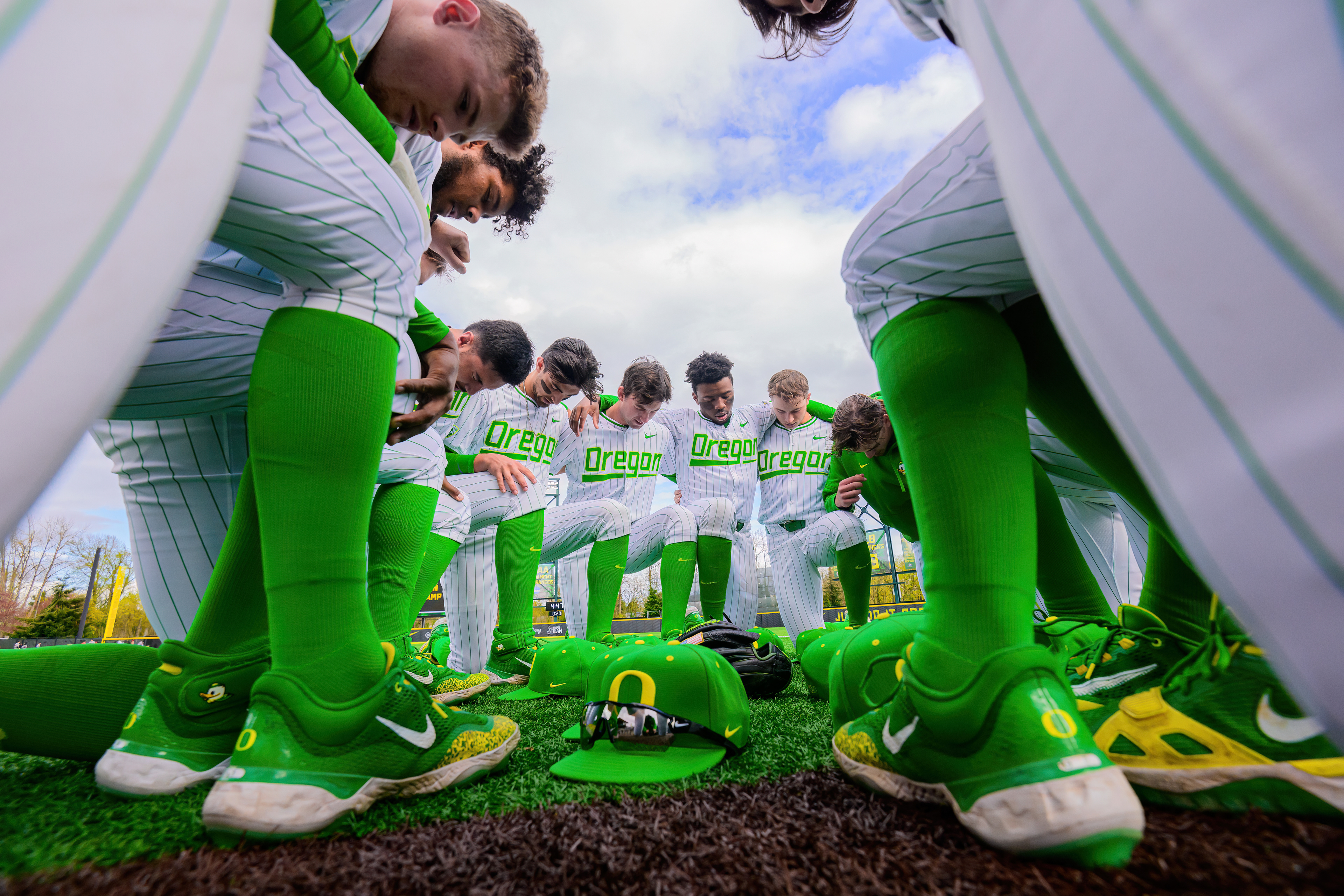 University of Oregon Ducks Baseball team members pray before their game versus the Seattle University Redhawks in a home game at PK Park in Eugene, Ore., on Mar. 27, 2024.