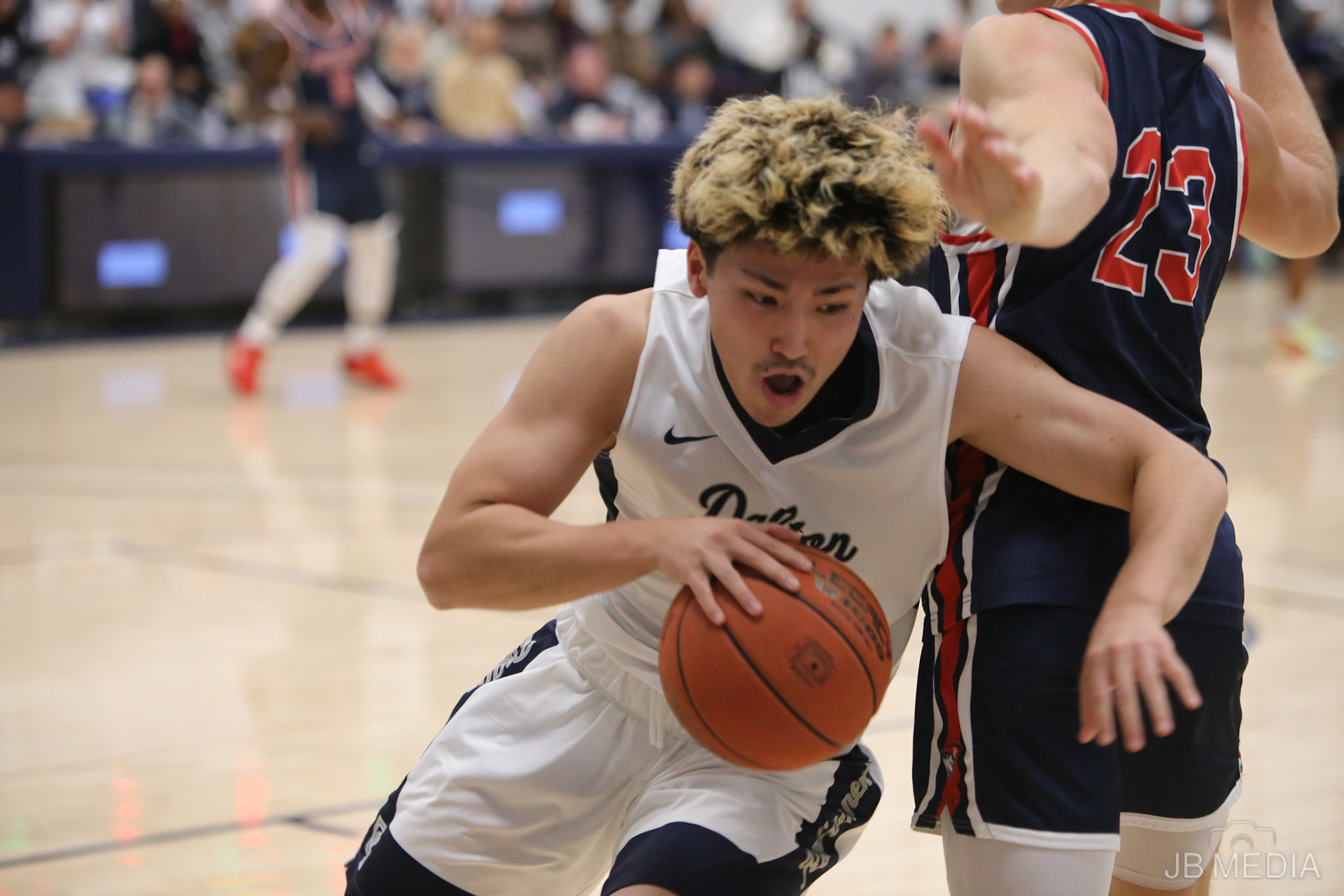 DALTON, GA - Dec 2:  Kyoya Sasaki #20 of the Dalton State Roadrunners (G) drives past Matthew Cromer #23 of University of the Cumberlands Patriots (G) at Bandy Gymnasium in Dalton, GA. The Roadrunners defeated the #9 Patriots 88-80. (Photo by Jeremy Barfield/JBfotomedia.com)