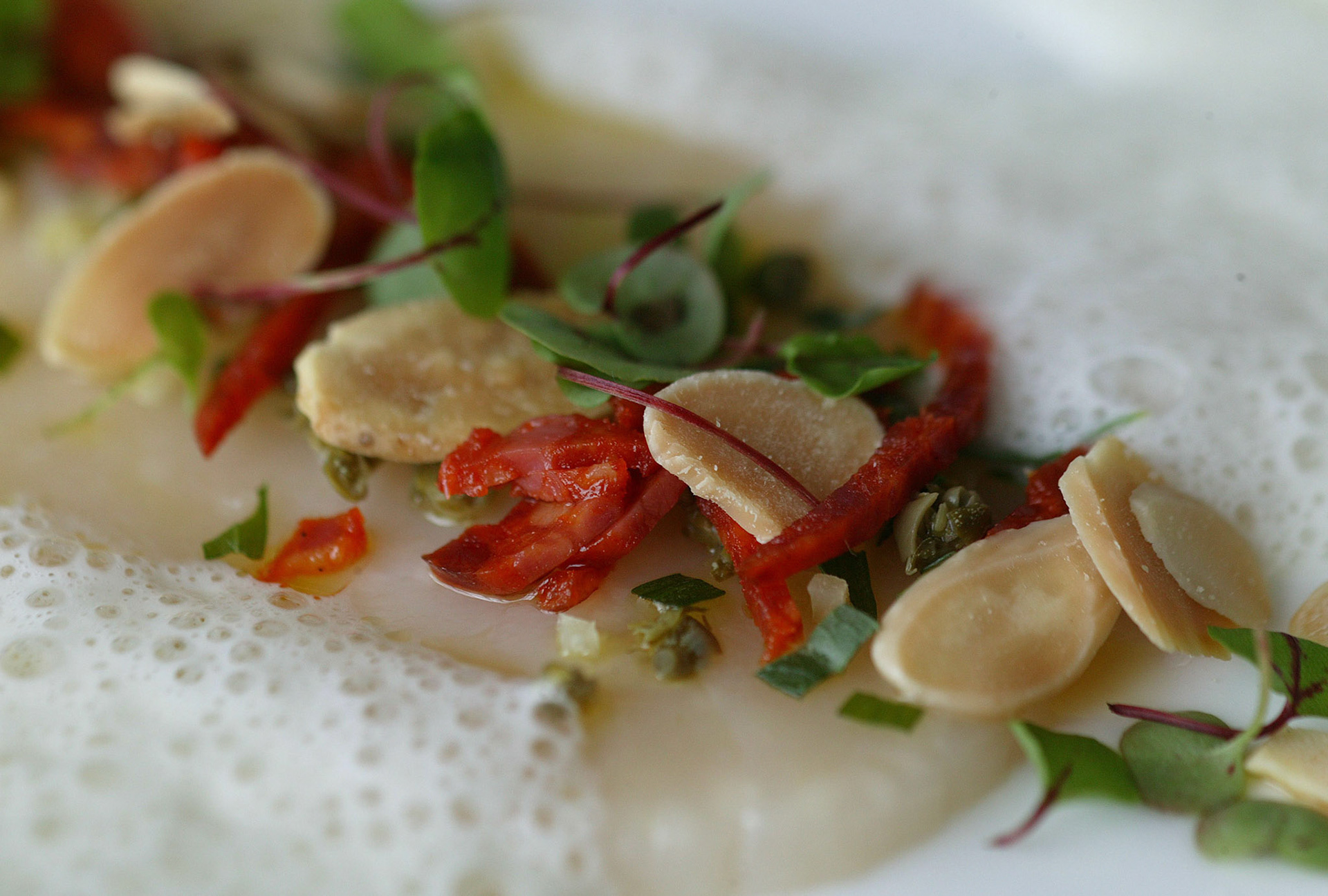 Scallops carpaccio with chorizo,capers and toasted almonds at Skylon  restaurant, Royal Festival Hall,London.