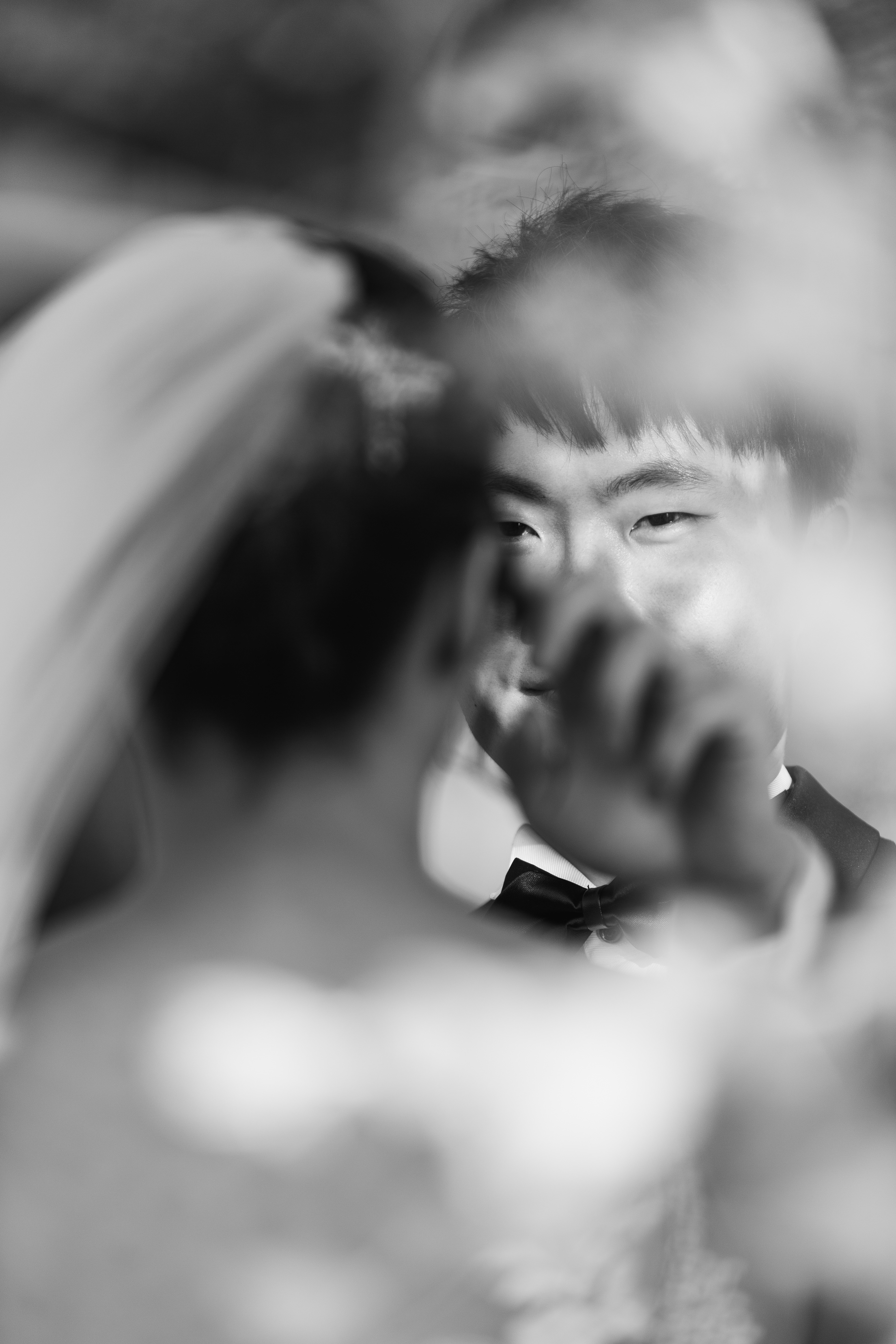 The groom wiping of tears of the bride whom is crying tears of joy. Phuket Krabi Samui Phang nga Thailand wedding photographer photographing wedding photography of a beautiful beach wedding in Phuket