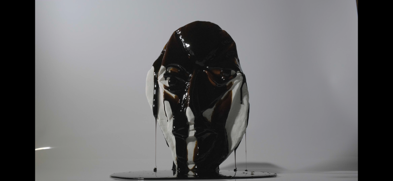 Middle of PHILANTHROPIST III (14 min video piece on loop, sugar plate cast sculpture and molasses)