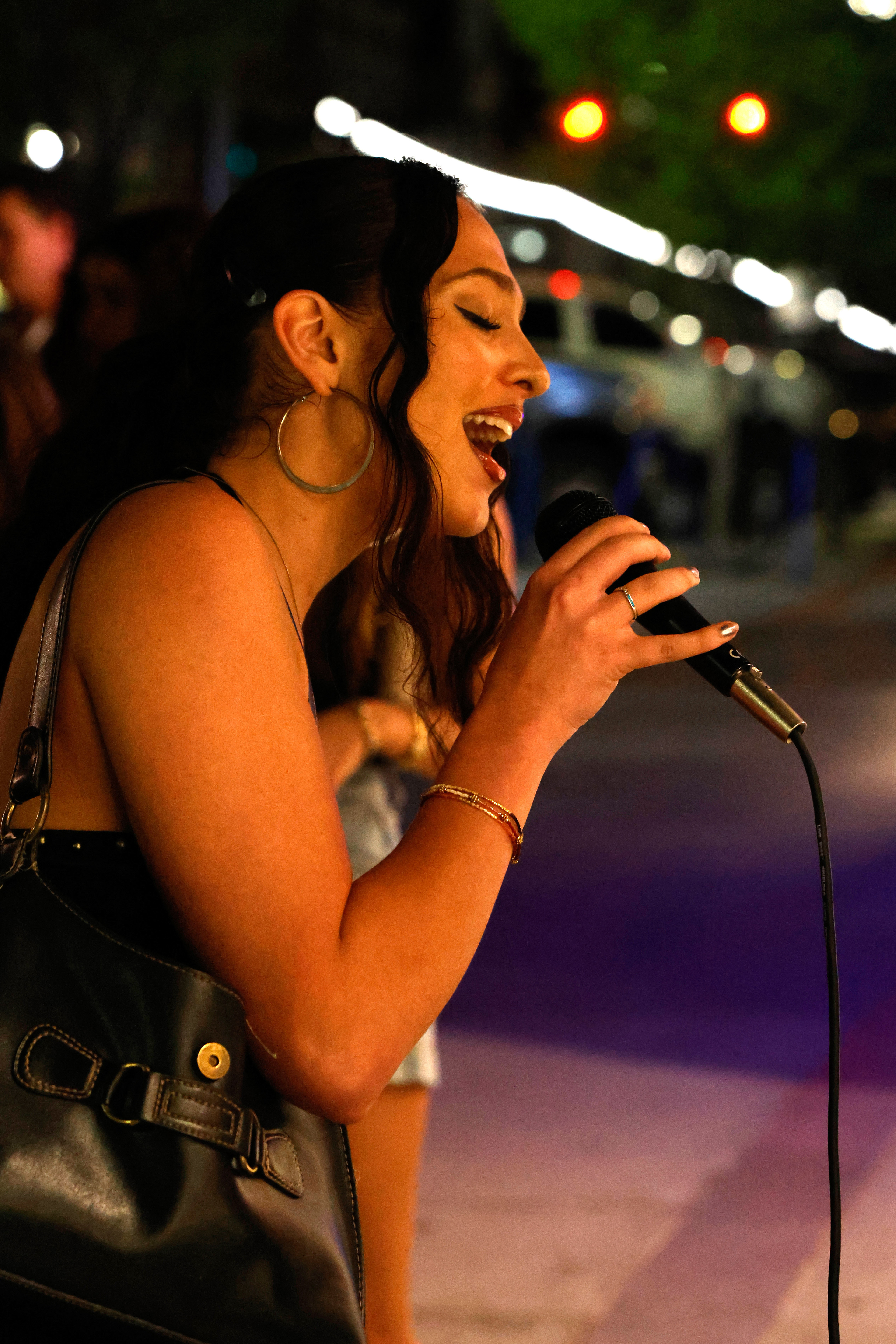 A woman sings while Andrew Hsu plays the piano in downtown Athens, Georgia, on Thursday, April 3, 2025. Andrew Hsu sometimes collaborates with other musicians when street performing.