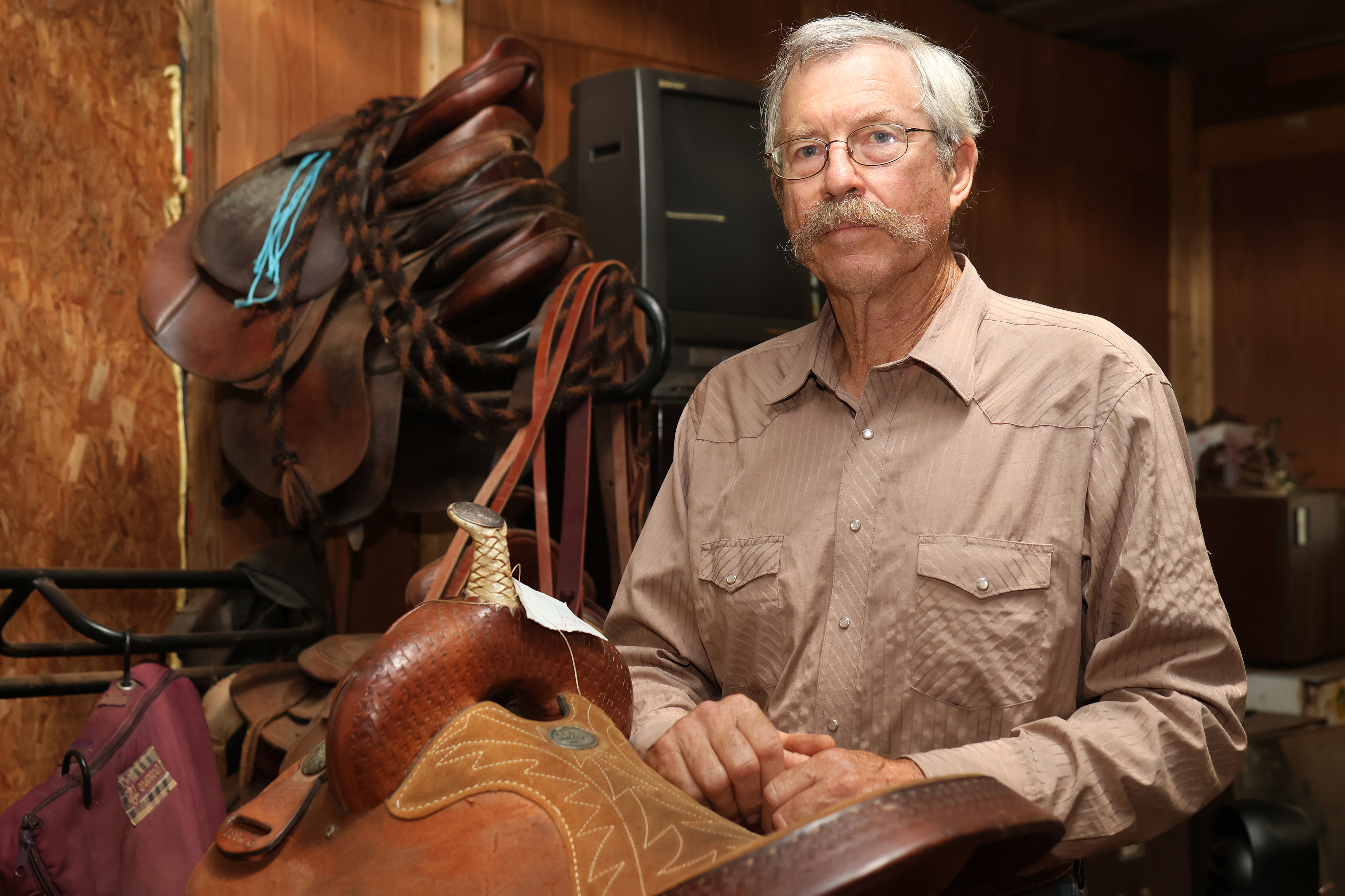 Ed Huie poses for a portrait in his workshop in Ila, Georgia, on Friday, September 7, 2025. Huie was a horse trainer for many years and started his saddle making business in 2013, after years of repairing his own saddles.