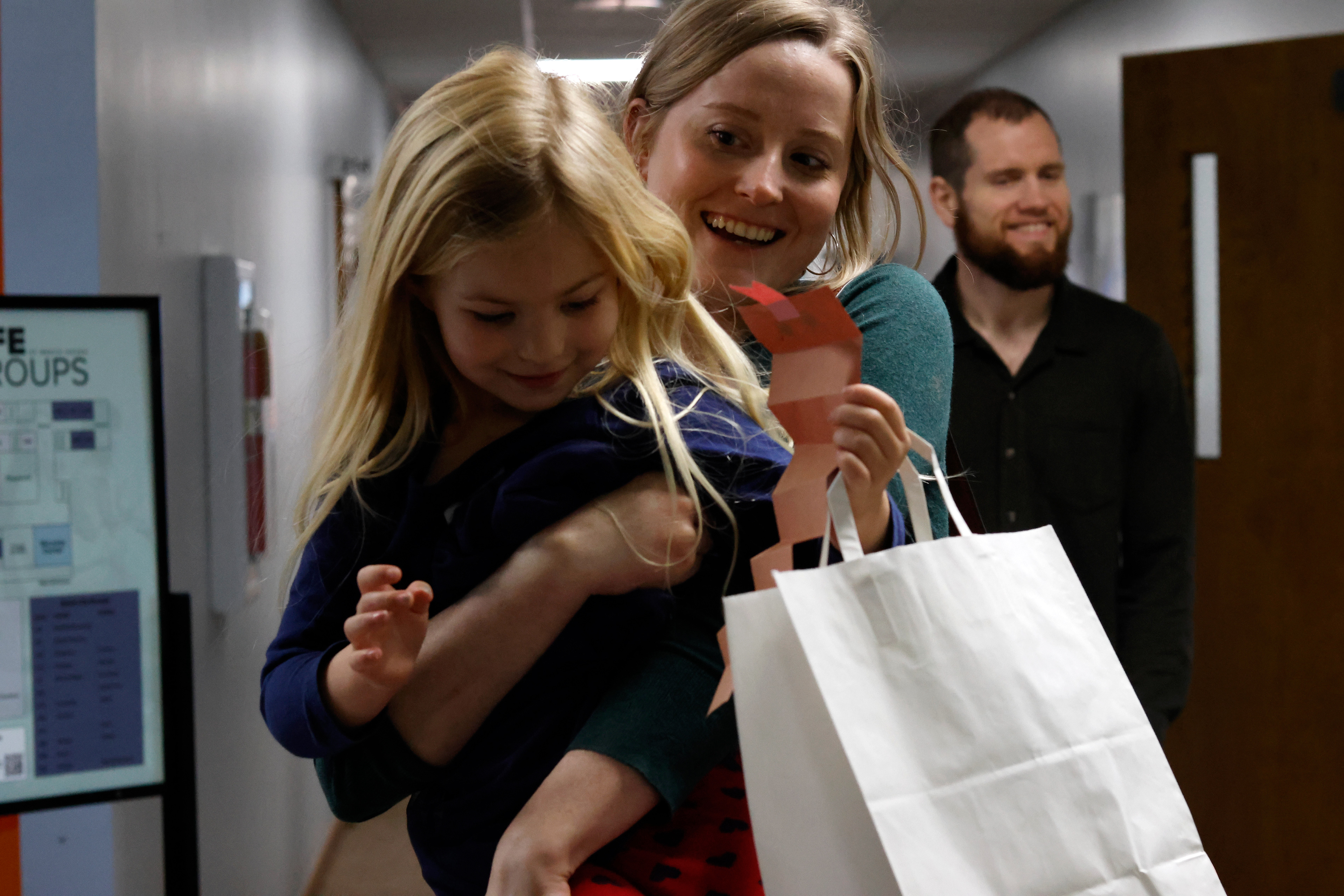 Jess Gillespie carries Lydia Crumbley down the hall at Beech Haven Church in Athens, Georgia, on Sunday, February 16, 2025. Gillespie is Crumbley's aunt and they both attend Beech Haven Church regularly. 
