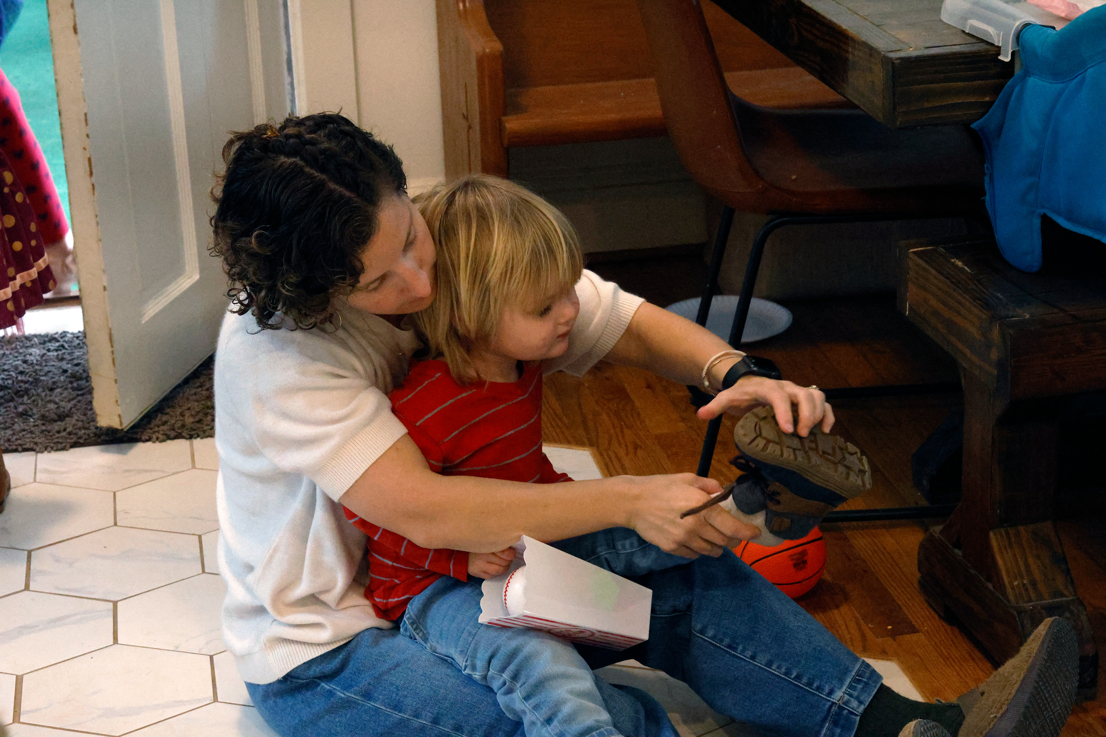 Jordan Crumbley helps her son, Ezra Crumbley, put his shoes on in their home in Athens, Georgia, on Sunday, February 16, 2025. The Crumbleys try to leave for church by 9 a.m. on Sundays.