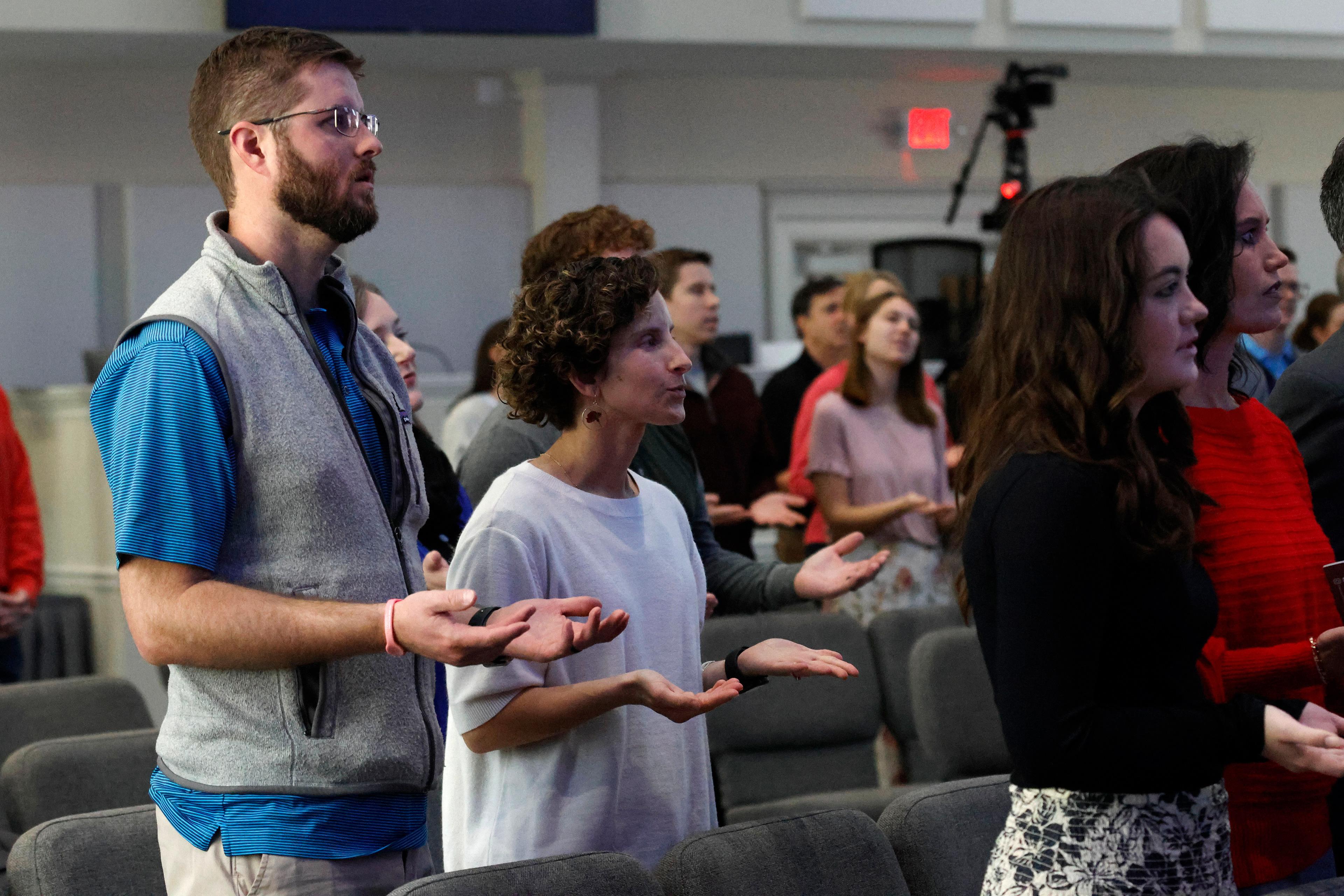 Daniel and Jordan Crumbley pray with the pastor during Sunday Worship at Beech Haven Church in Athens, Georgia, on Sunday, February 16, 2025. The Crumbleys regularly attend Sunday Worship in person. 